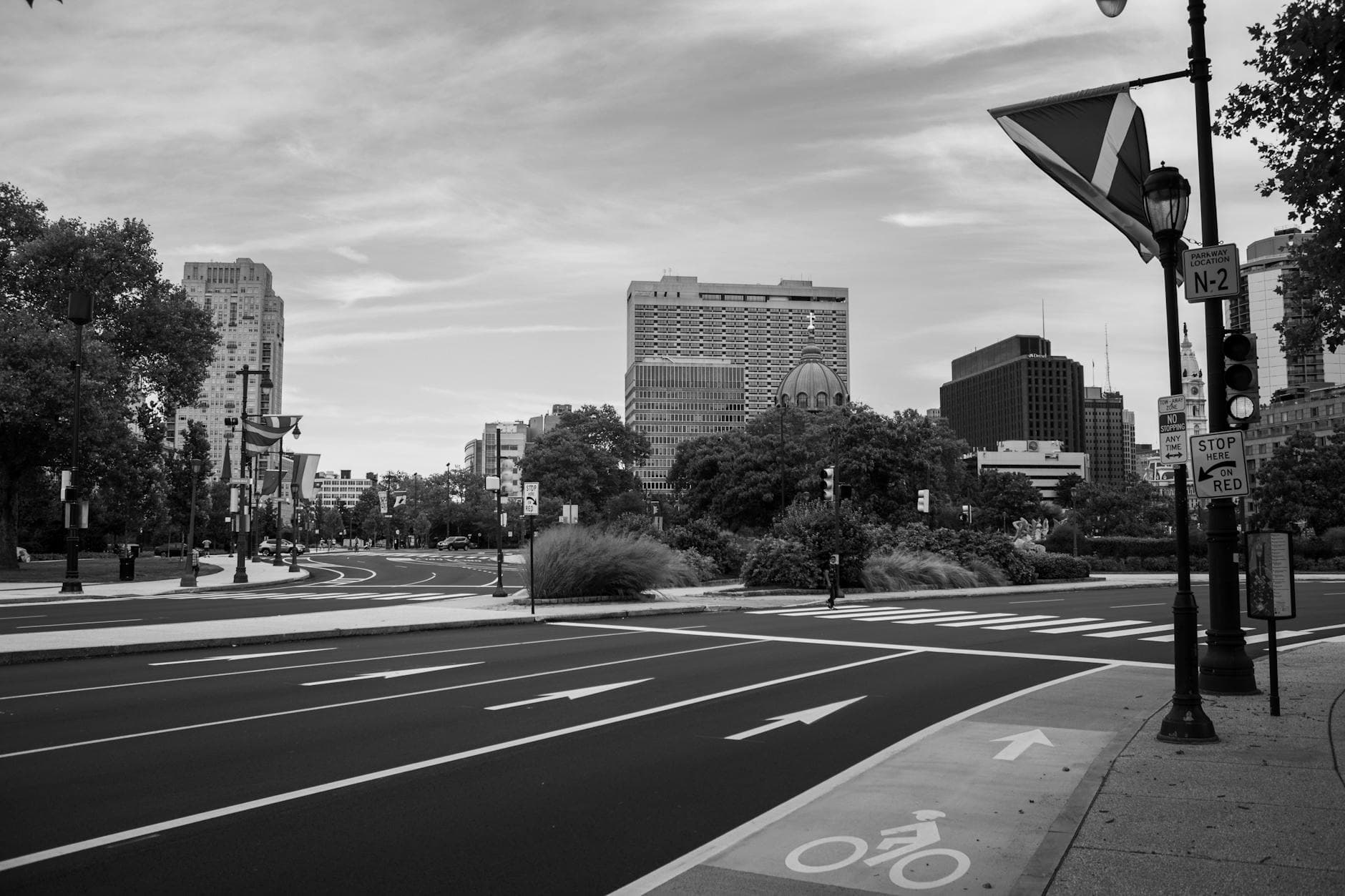 A grayscale view of Philadelphia's urban street scene featuring modern buildings and clear road markings.