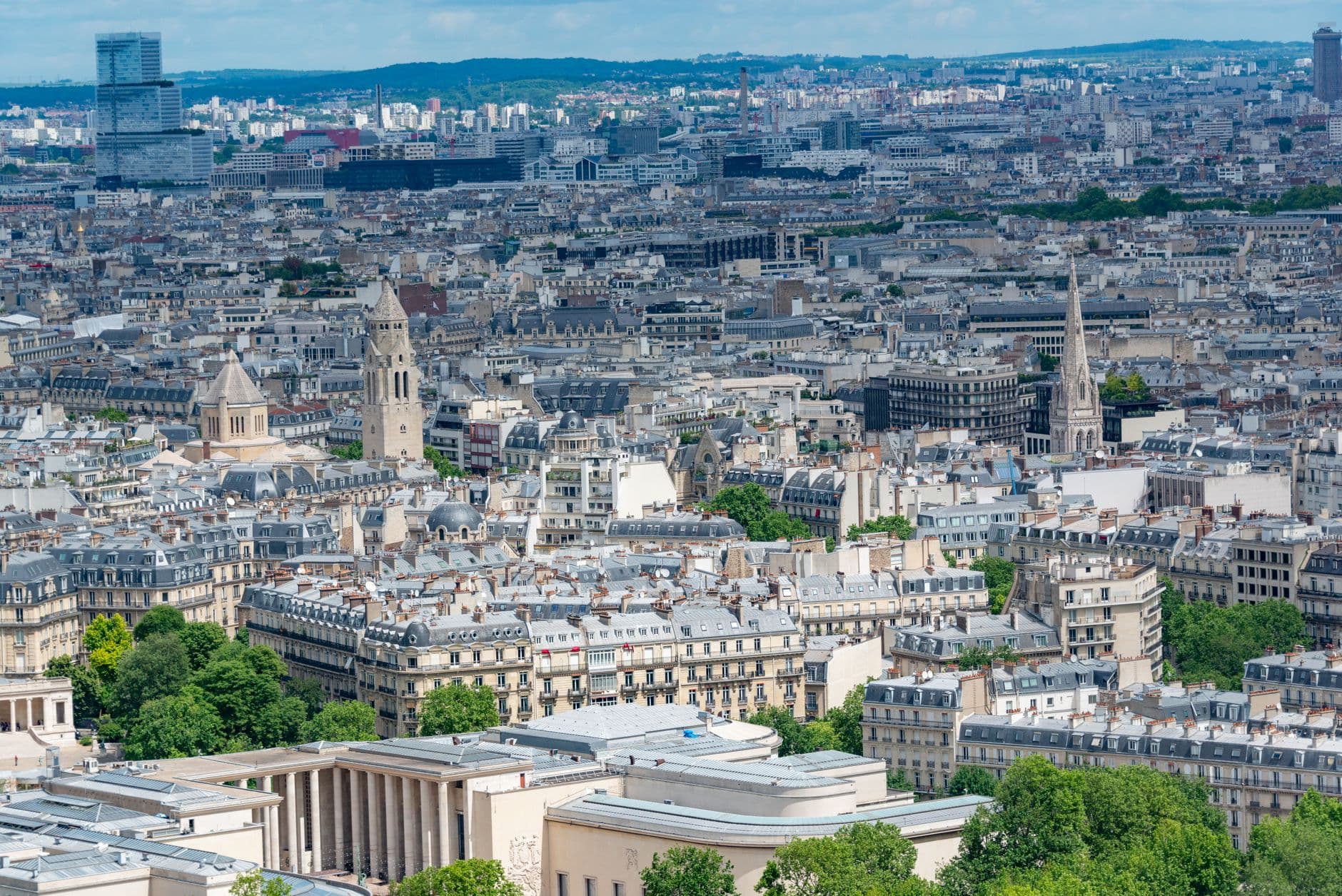 Stunning aerial view of Paris showcasing historic architecture and skyline on a clear day.