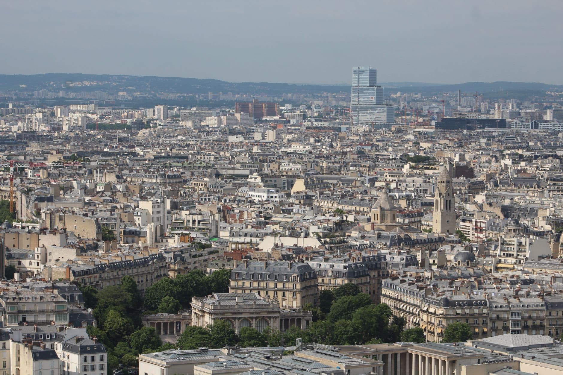 Panoramic aerial view of Paris showcasing historical architecture and skyline.