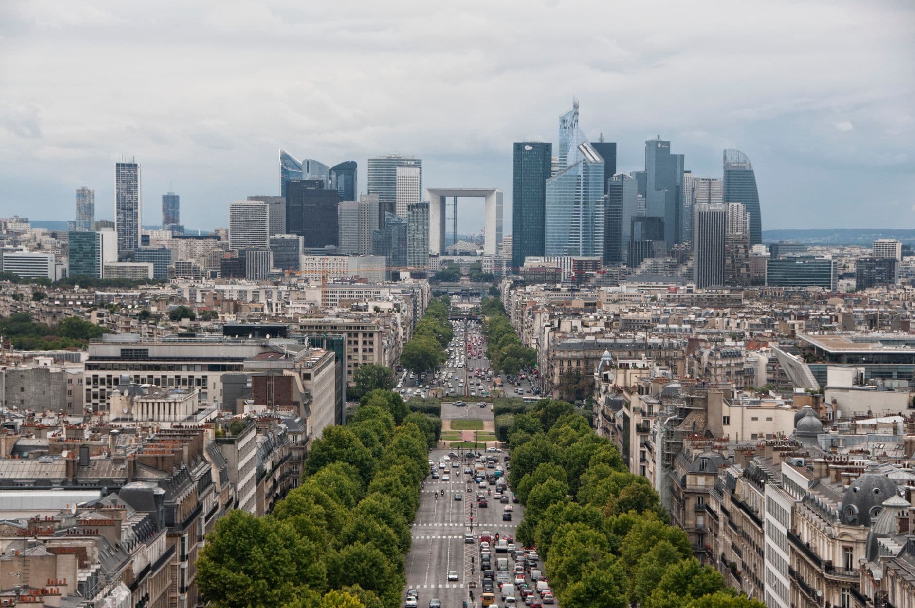 Impressive aerial view of Paris' La Défense district skyline, capturing urban architecture and busy streets.