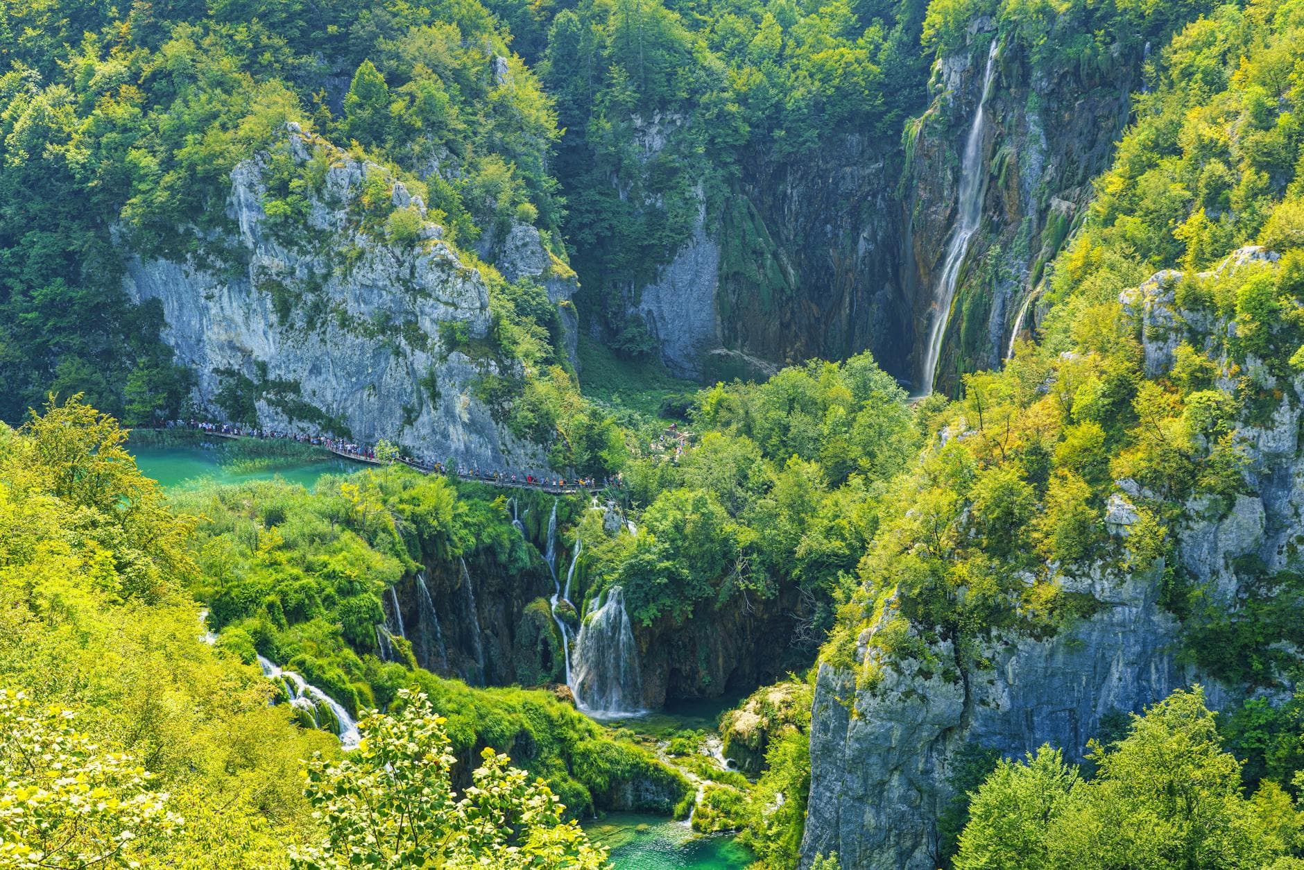 Stunning aerial view of lush waterfalls in Plitvice Lakes National Park, Croatia.