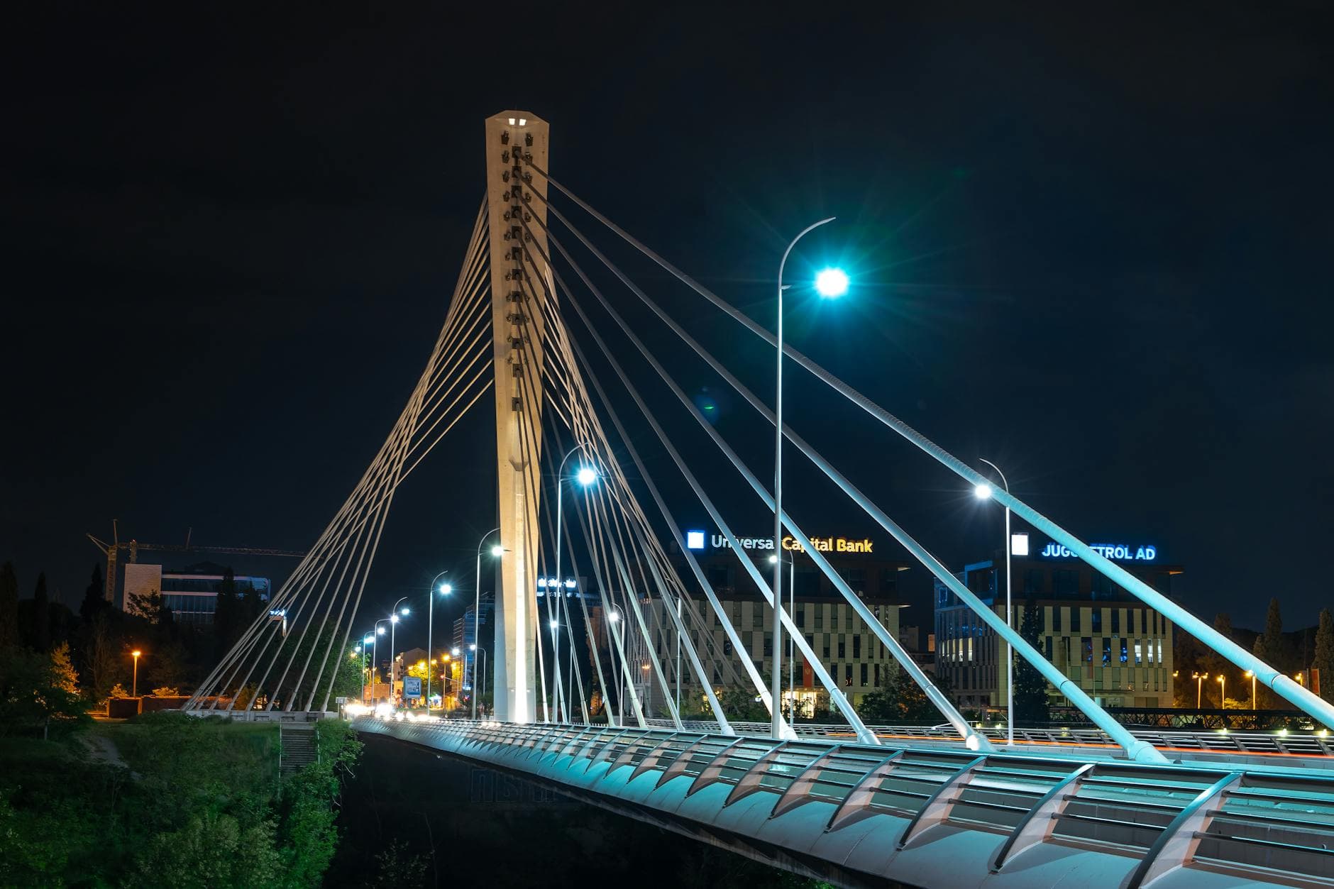 Night view of the iconic Millennium Bridge in Podgorica, Montenegro, beautifully illuminated.