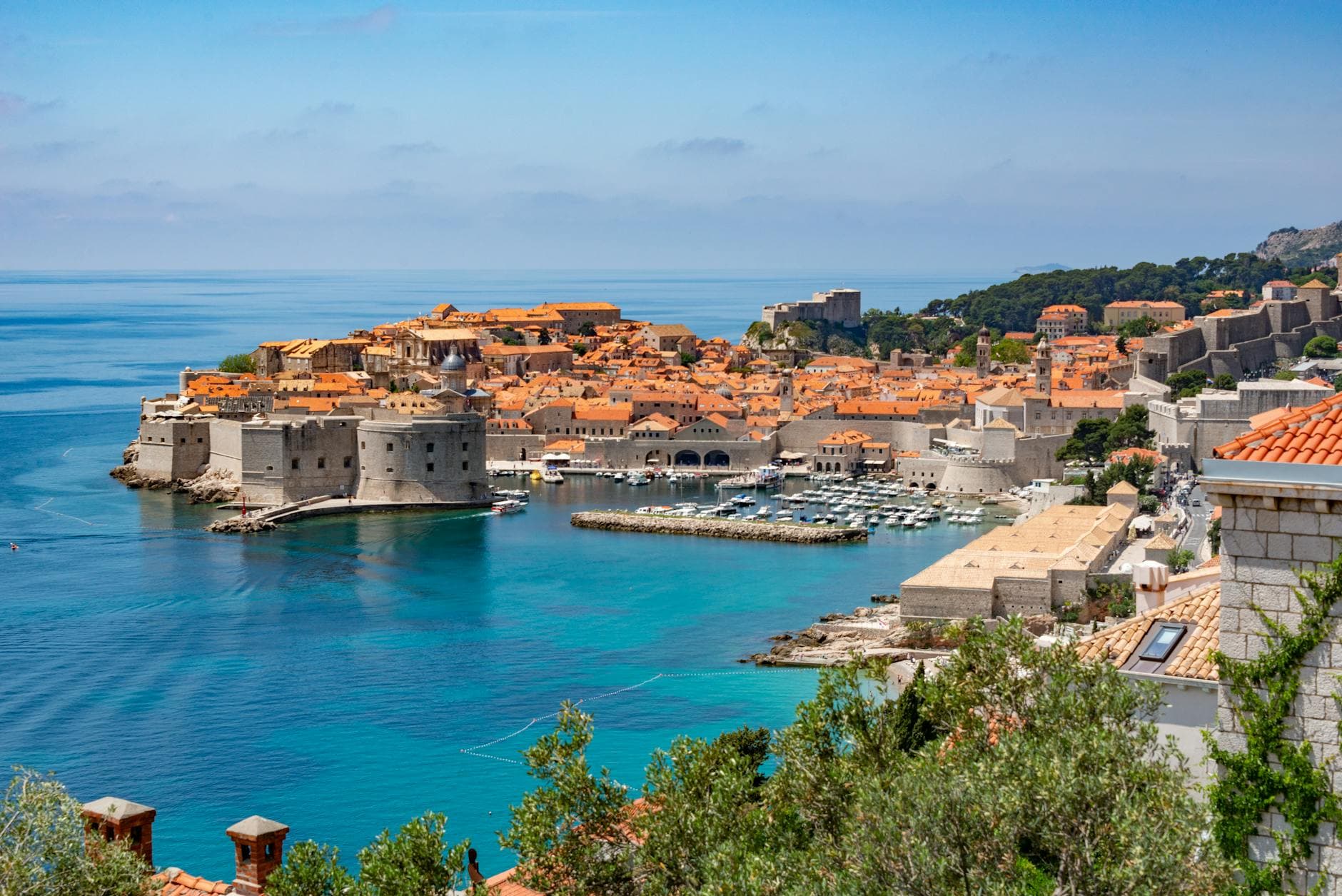 Scenic view of Dubrovnik's historic old town with iconic city walls and Adriatic coastline.