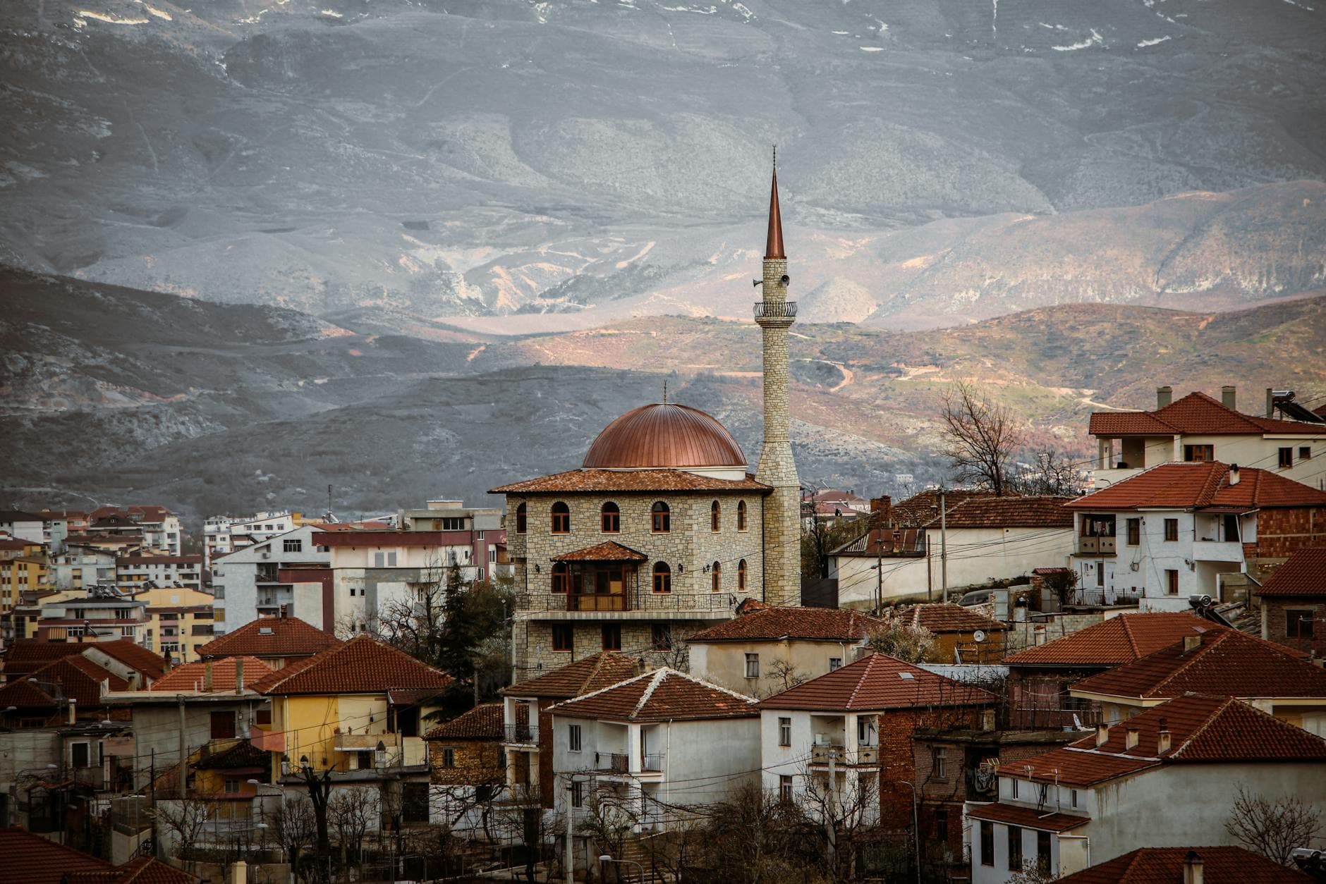 Beautiful Pogradec cityscape with mosque and mountain backdrop, perfect for travel and urban landscapes.