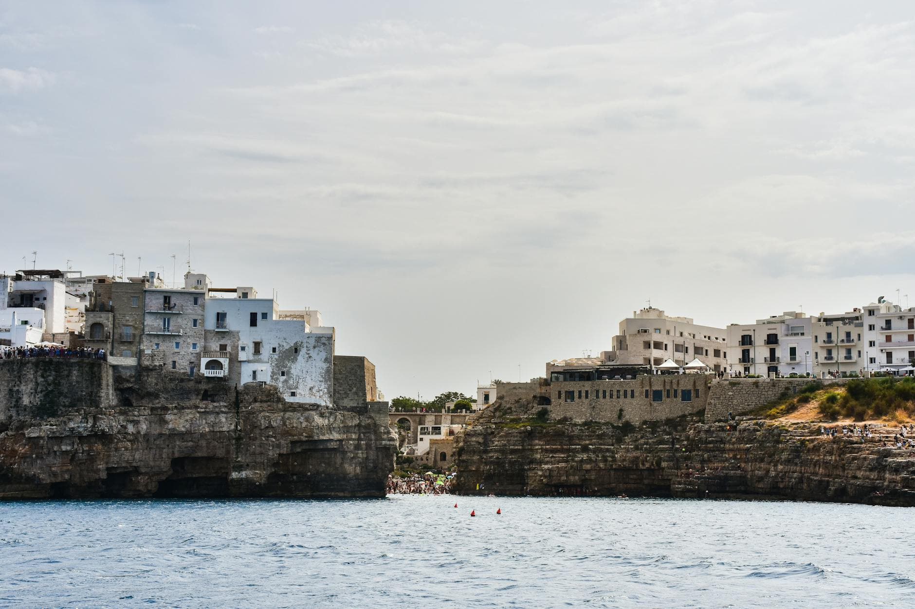 Explore the stunning cliffside architecture of Polignano a Mare in Apulia, Italy.