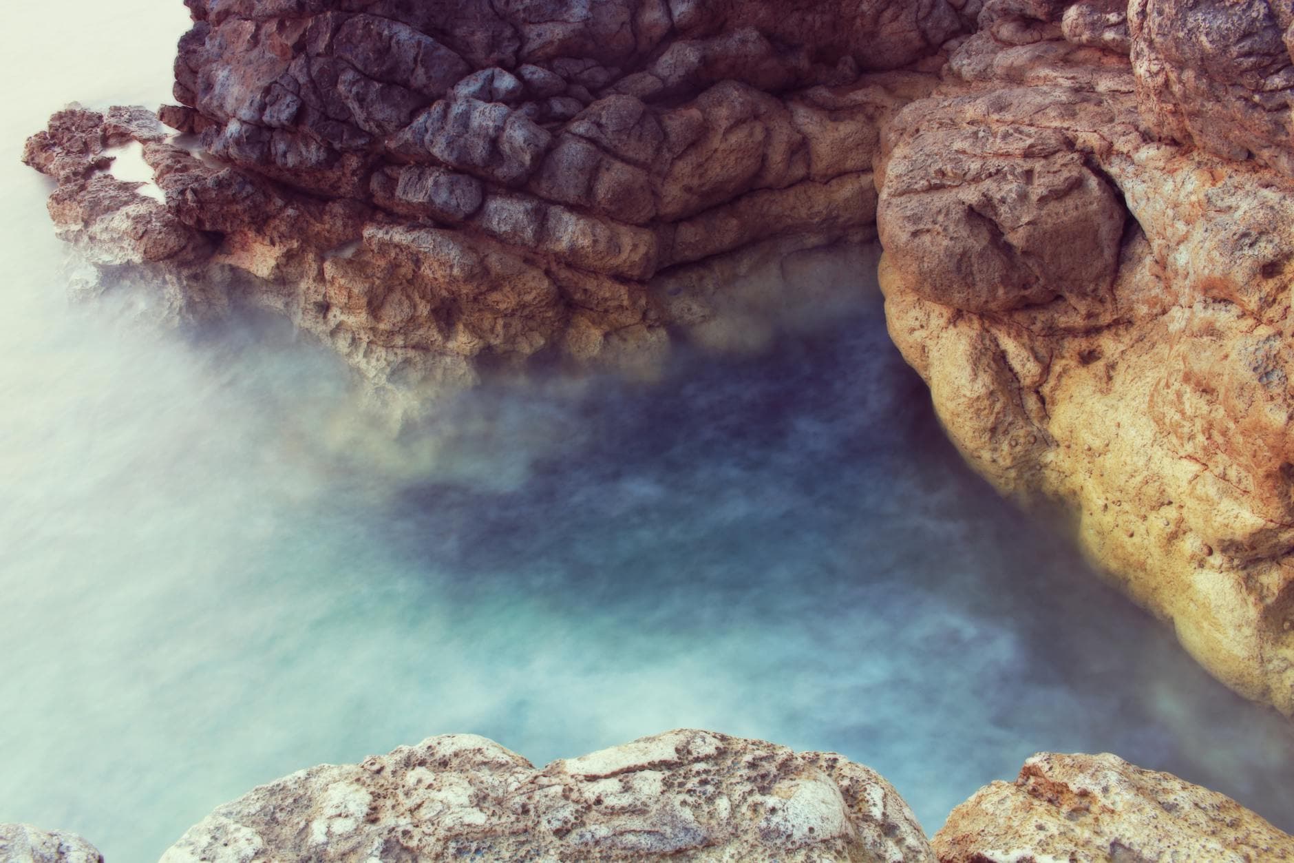 Serene view of rocky shoreline and ocean in Pula, Croatia, showcasing natural beauty.