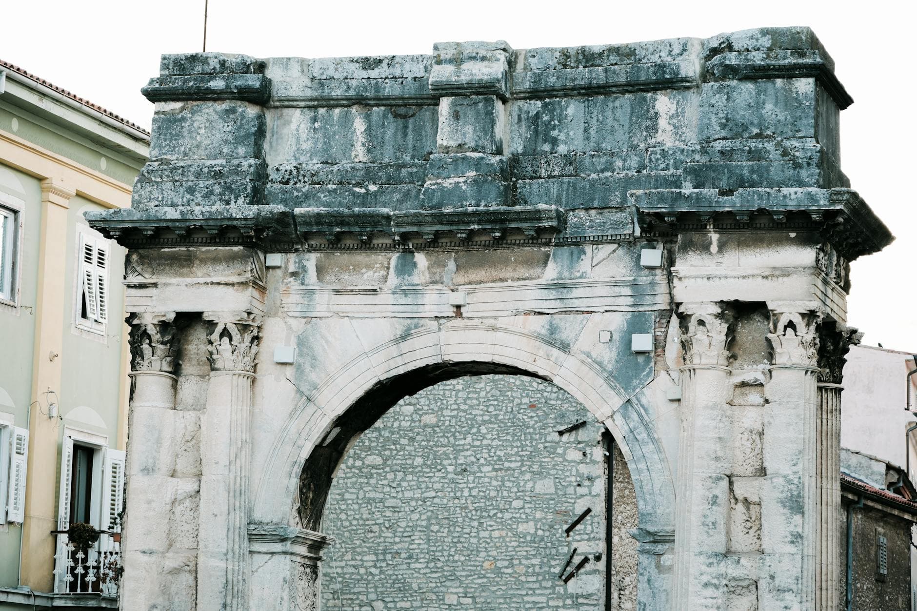 Close-up view of the iconic ancient arch in Pula, Croatia, showcasing detailed architecture.