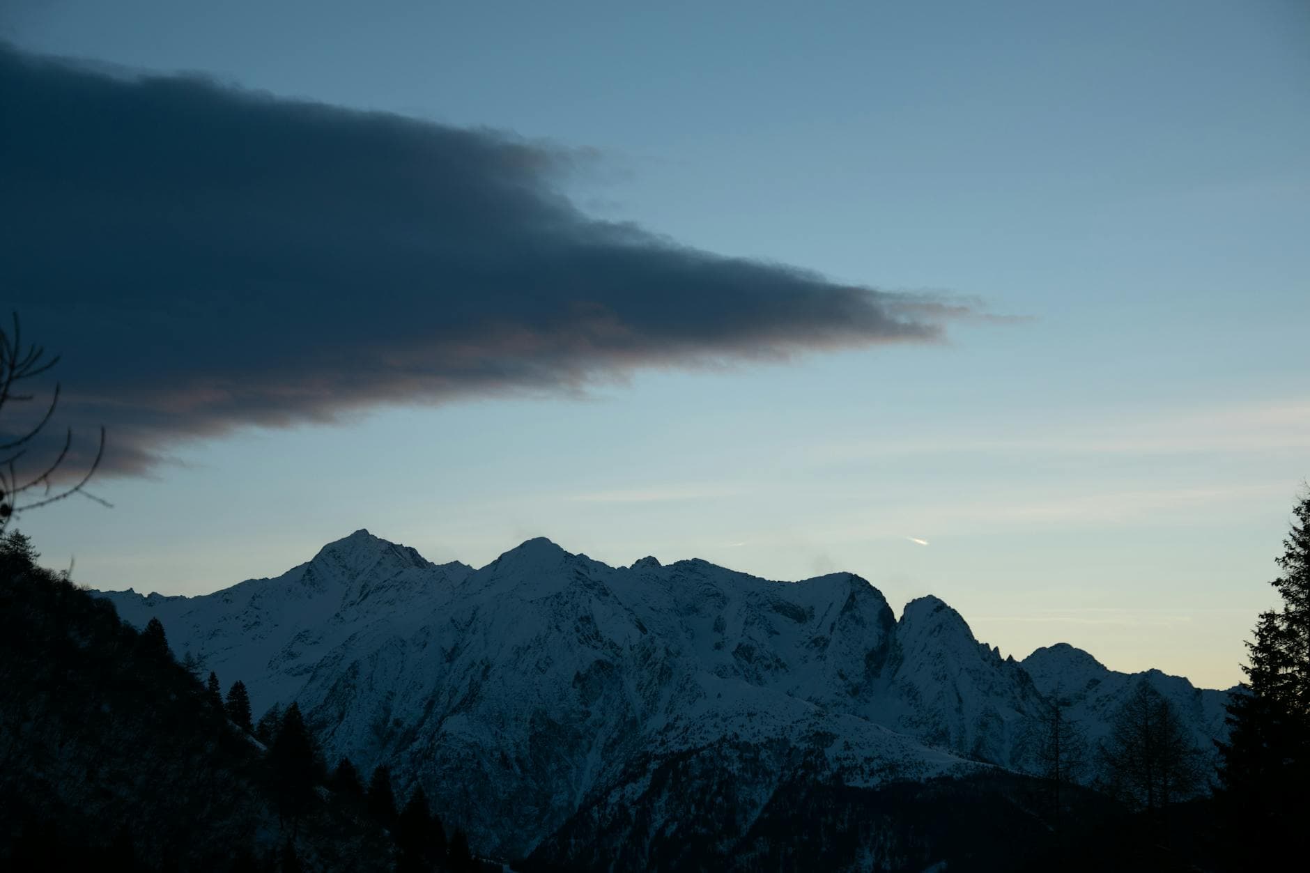 Breathtaking view of snowcapped mountains at sunset in Ponte di Legno, Italy.