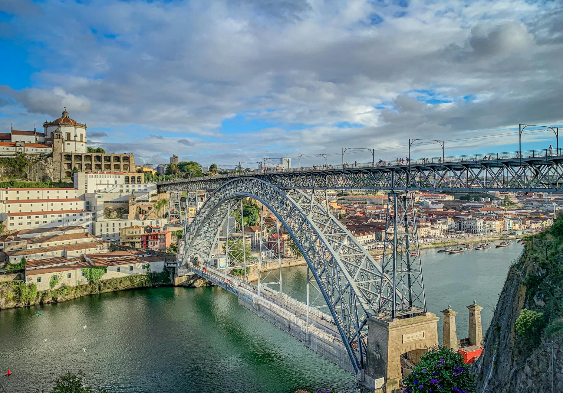 Stunning view of Dom Luís I Bridge over the Douro in Porto, Portugal, under a vibrant sky.