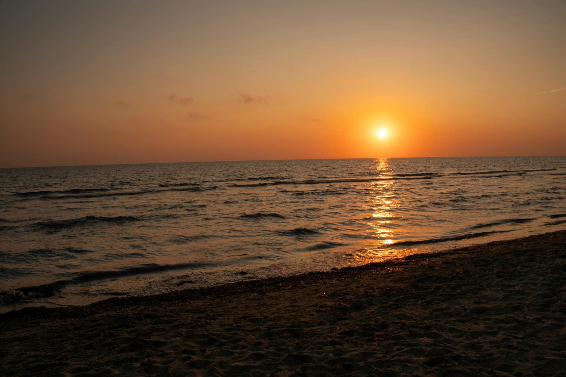 A captivating view of a sunset over the ocean along an Italian beach.