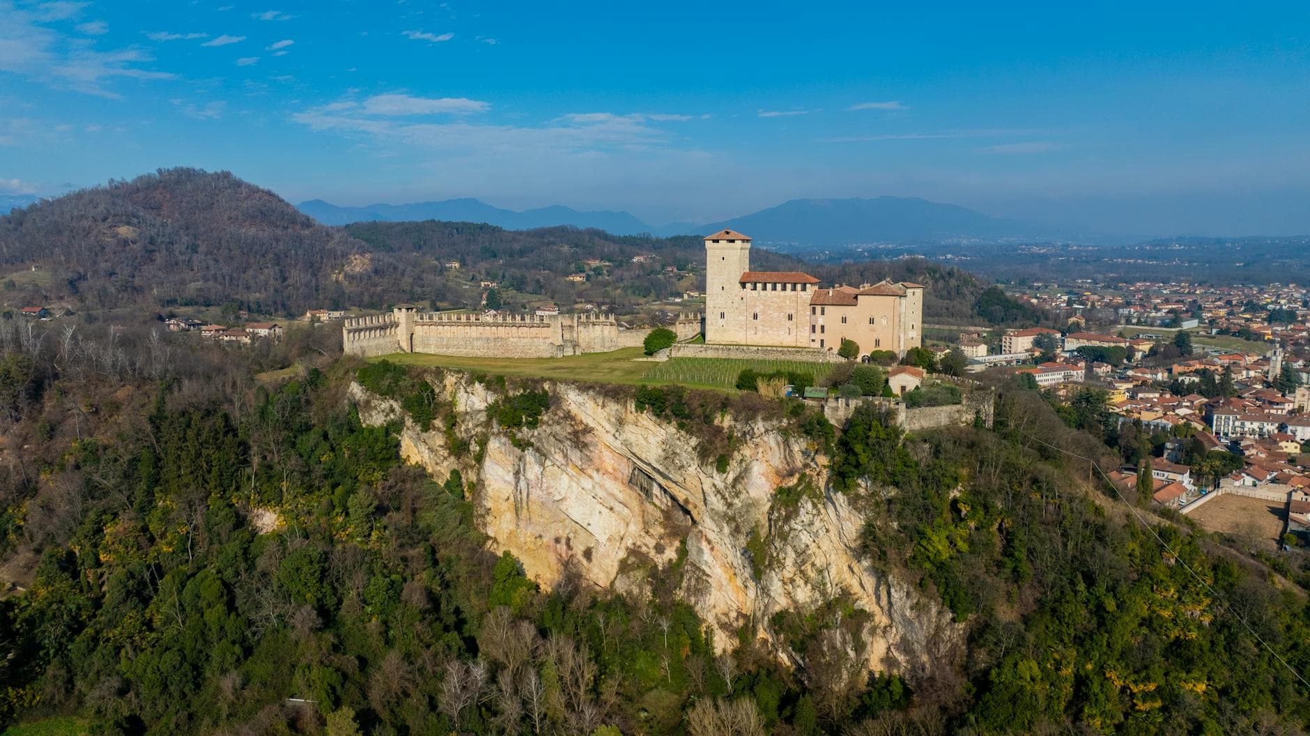 Aerial shot of the historic Angera Castle on a cliff in Lombardia, Italy.