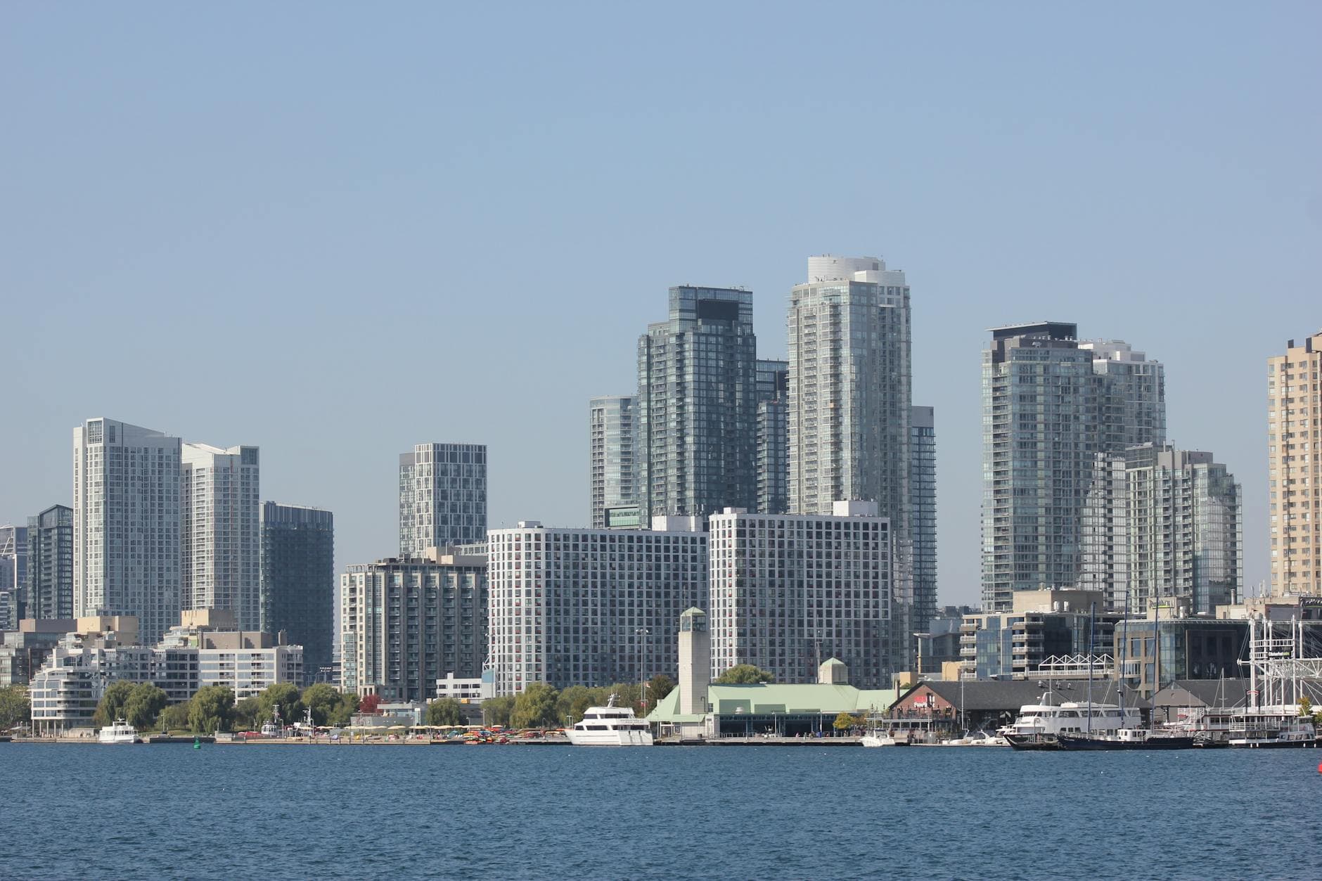 Vibrant cityscape featuring towering modern skyscrapers along a waterfront.