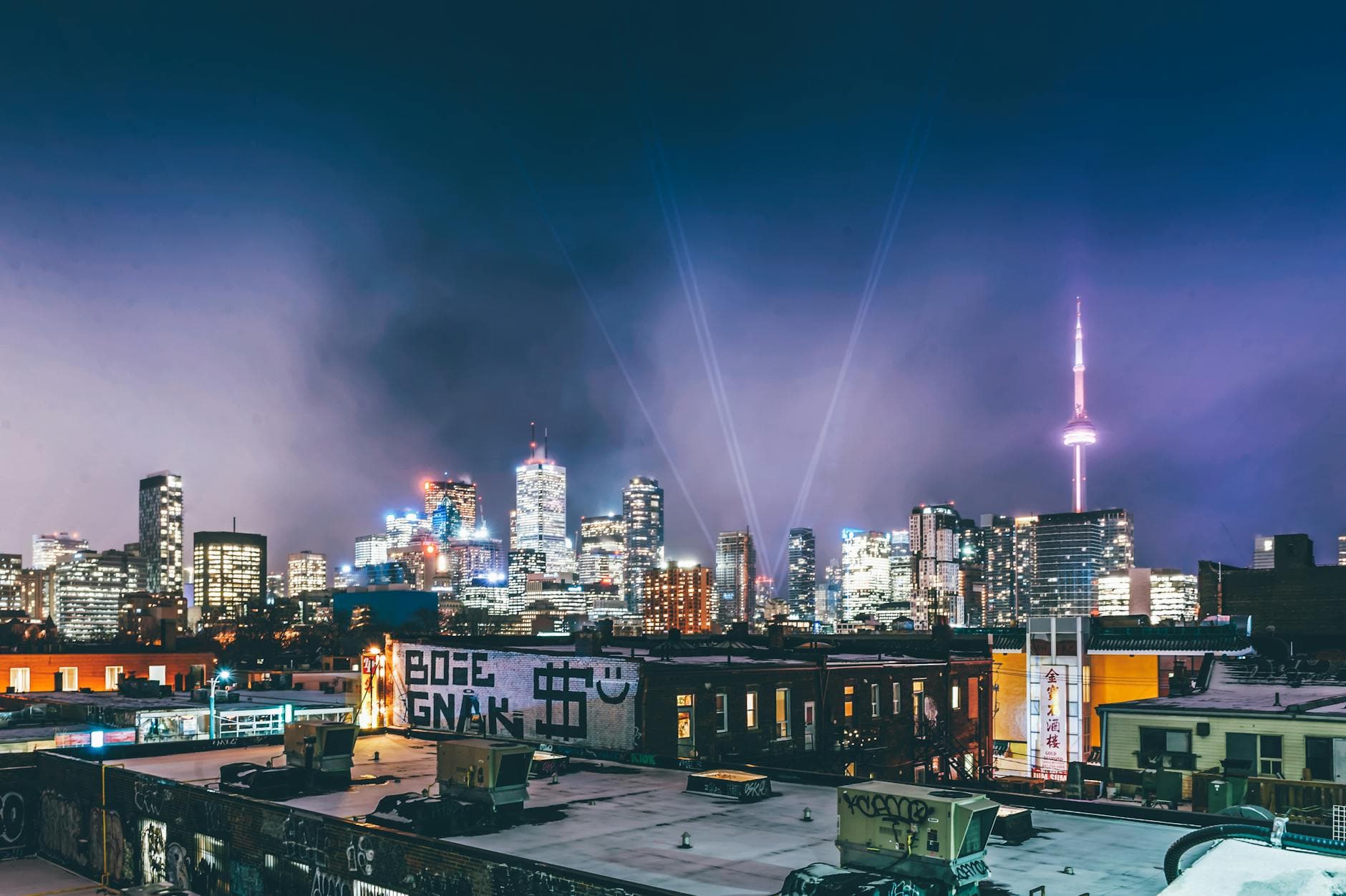 A stunning night view of Toronto's skyline featuring the illuminated CN Tower.