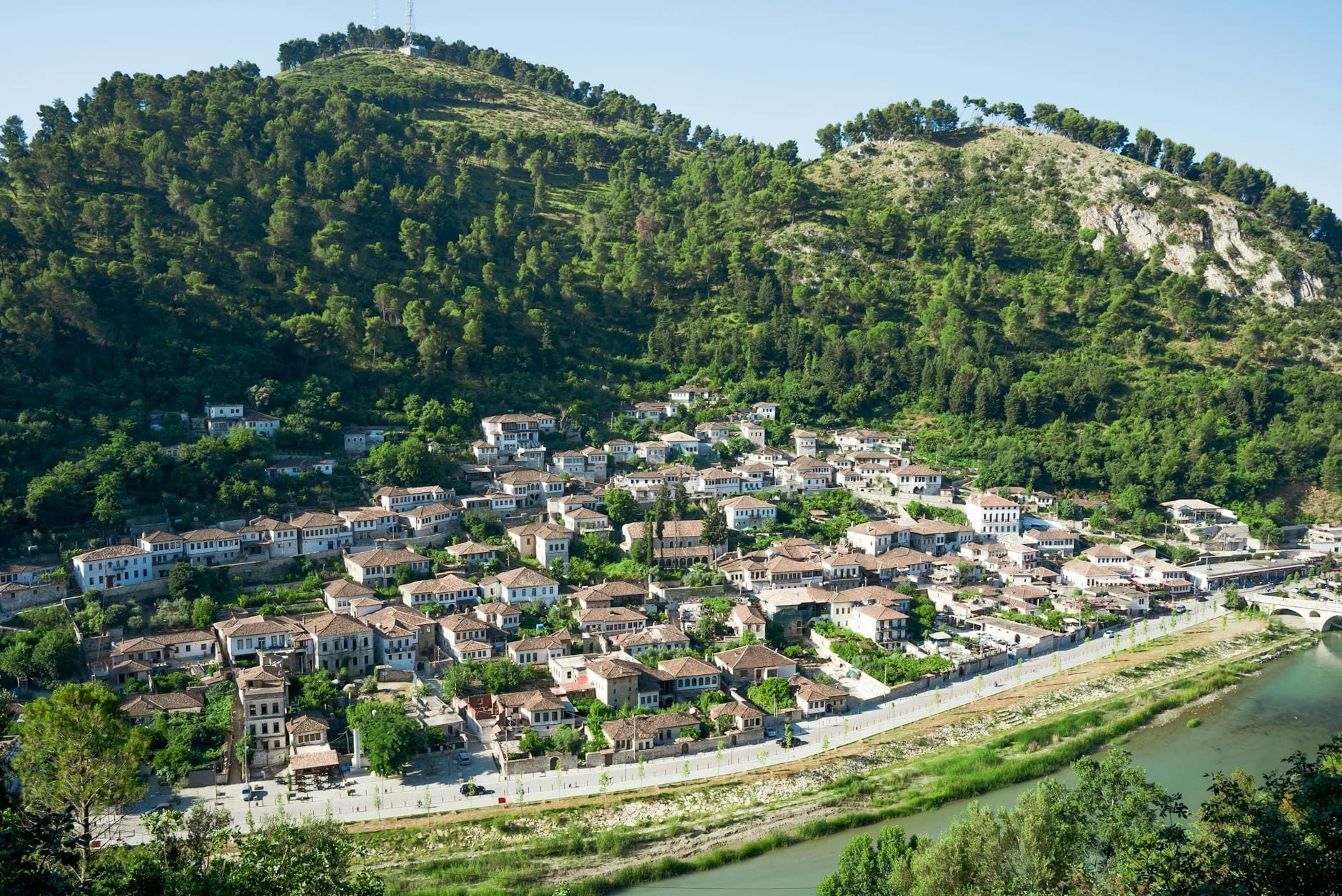 Explore the picturesque hillside town of Berat in Albania, showcasing its unique architecture.