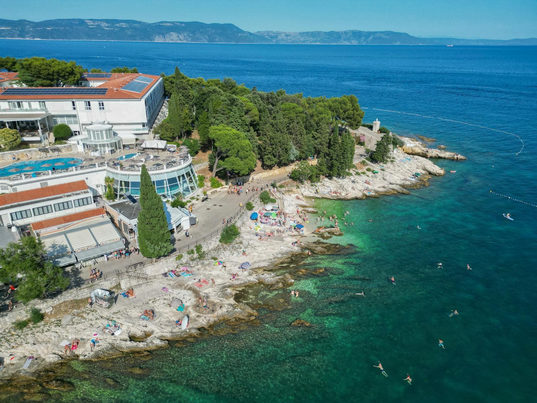 A stunning aerial view of Rabac's rocky coastline and turquoise waters in Croatia.