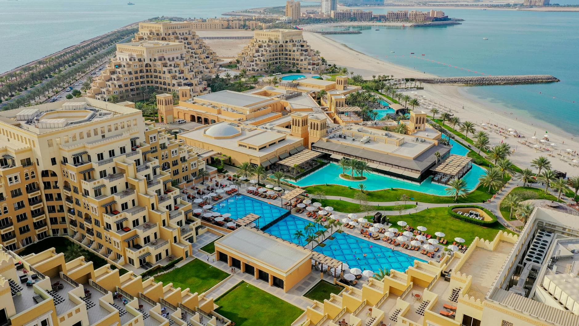Stunning aerial view of a luxury beach resort on Al Marjan Island, United Arab Emirates.