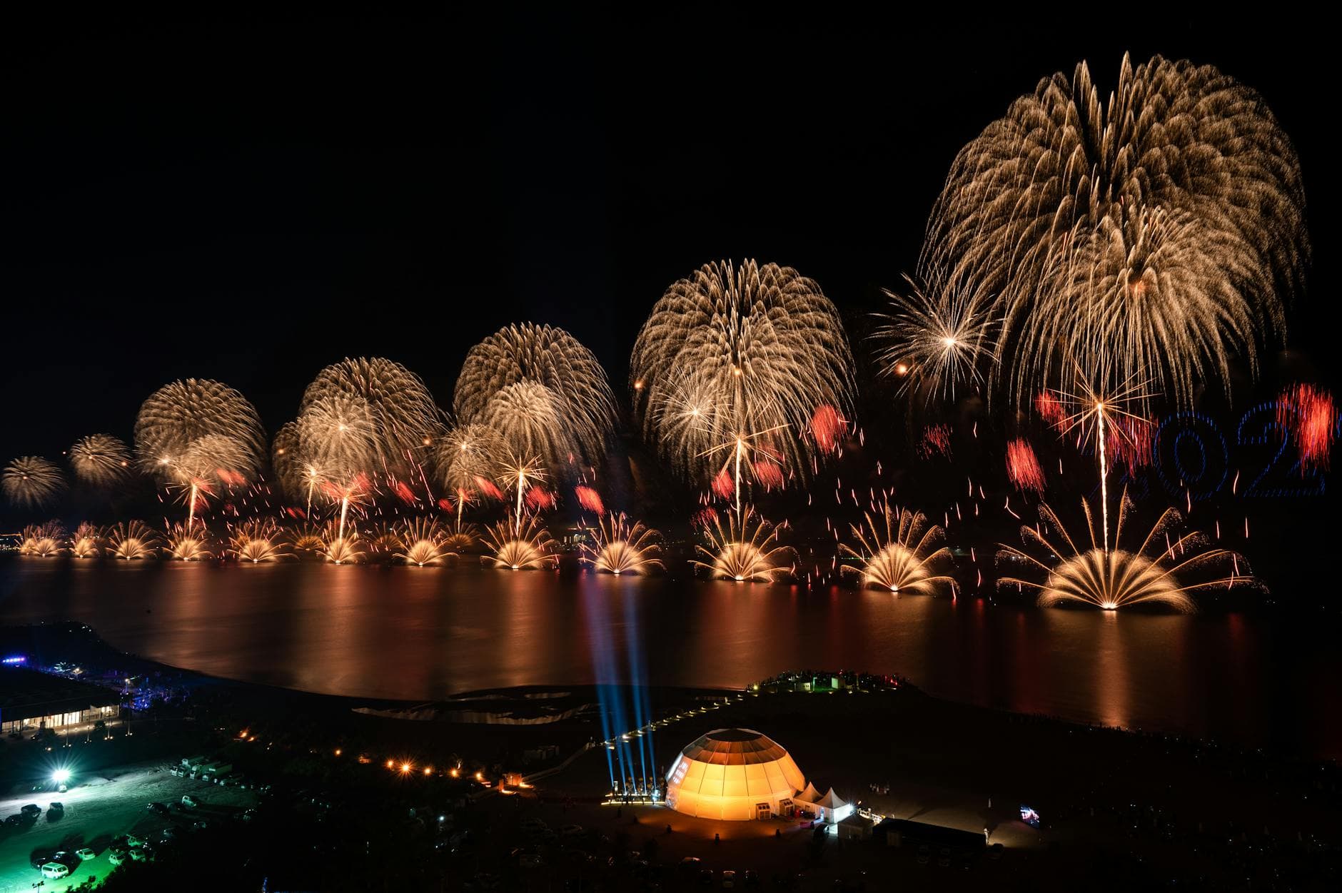 A breathtaking night view of fireworks over the waterfront in Ras Al-Khaimah, UAE.