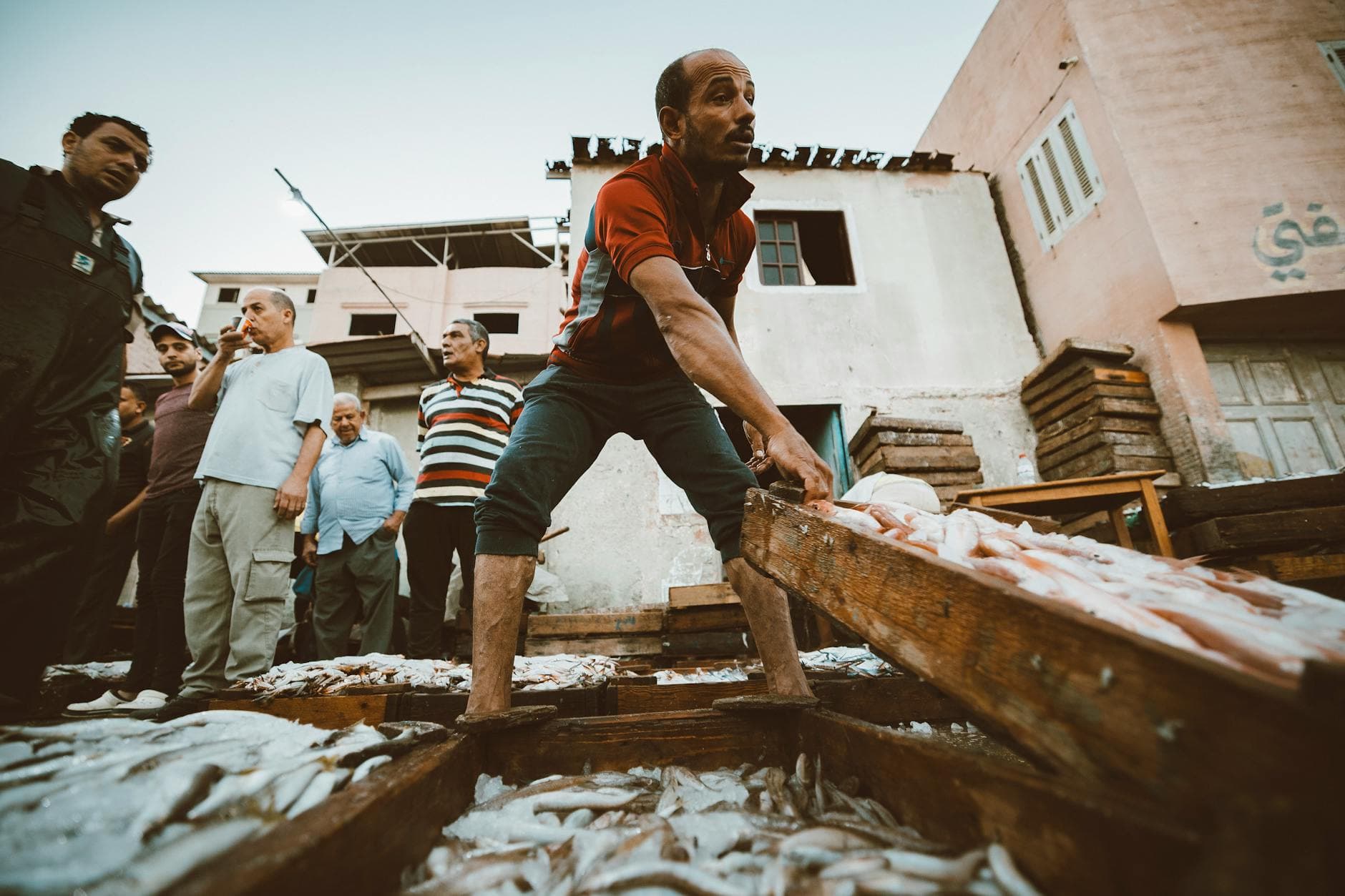 Vibrant street scene of fishermen in Ras El-Bar, Egypt.