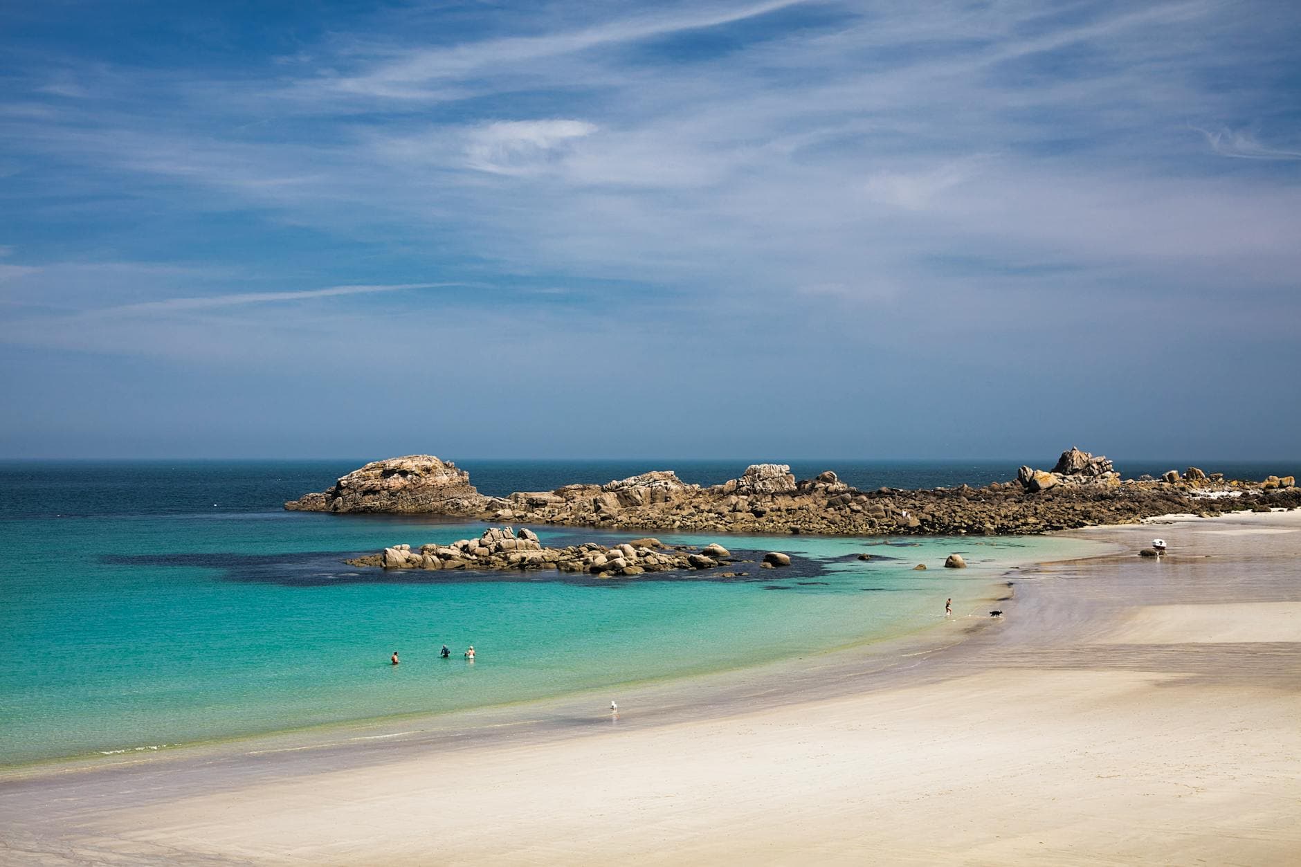 Stunning beach scene with rocks and azure water in Bretagne, perfect for travel inspiration.