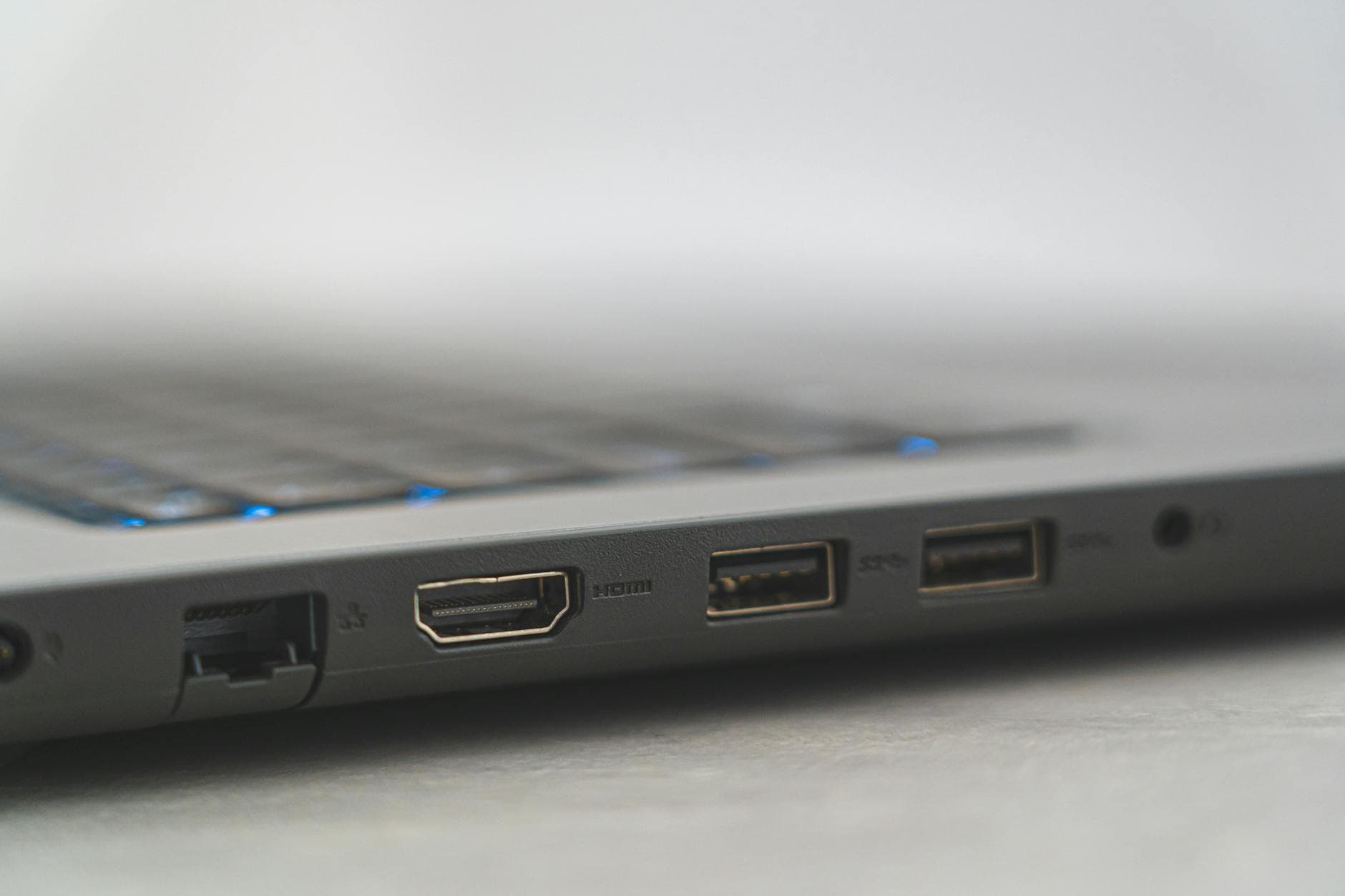 Detailed view of laptop ports including HDMI, USB, and Ethernet, showcasing connectivity options.