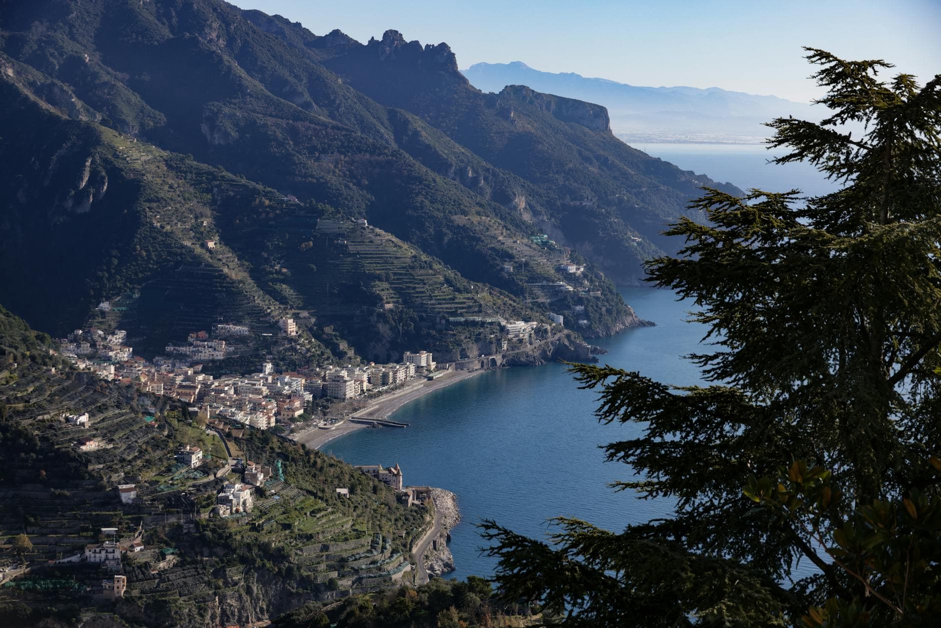 Breathtaking aerial view of Italy's Amalfi Coast, showcasing rugged cliffs and azure sea.