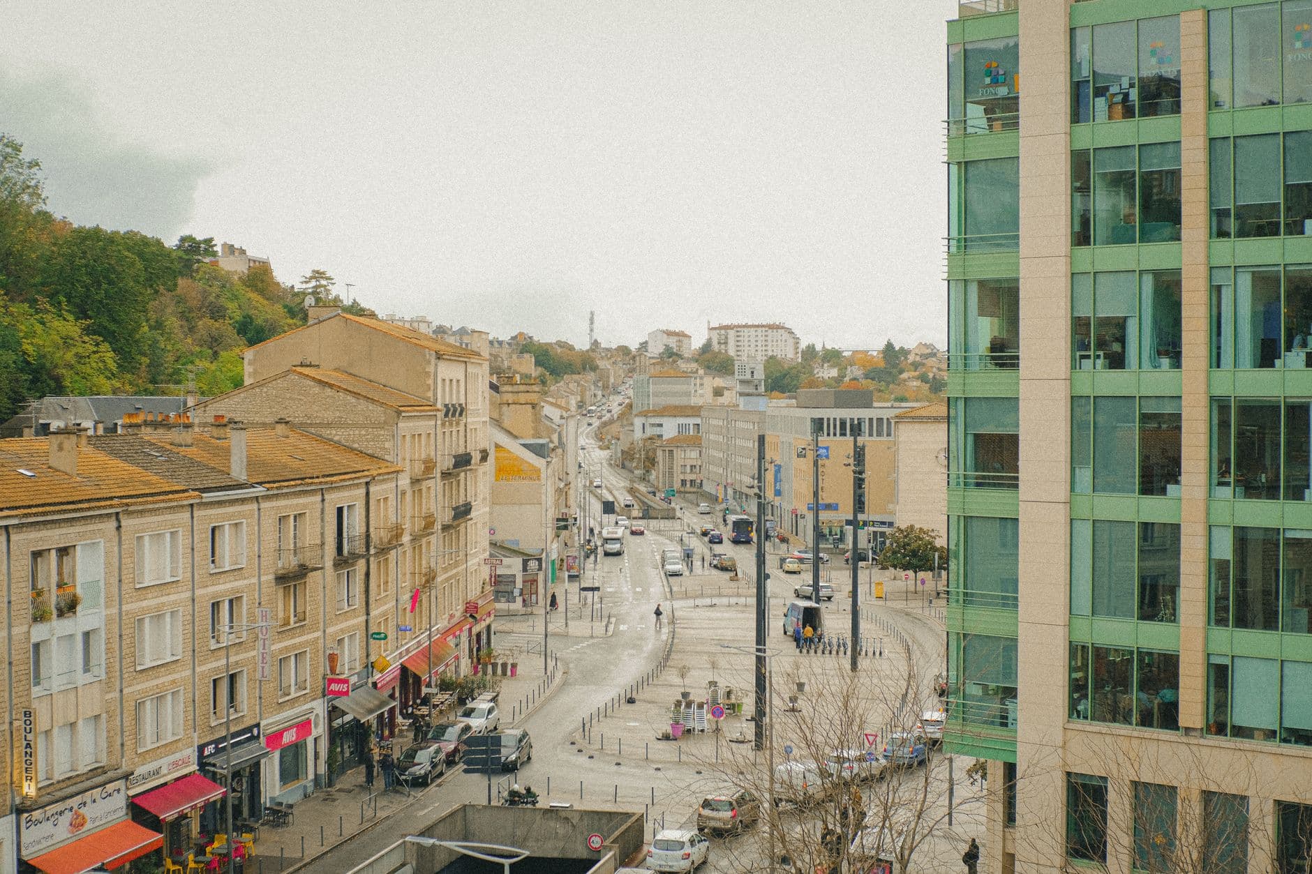 Busy street view of Poitiers, France, showcasing modern and classic architecture.