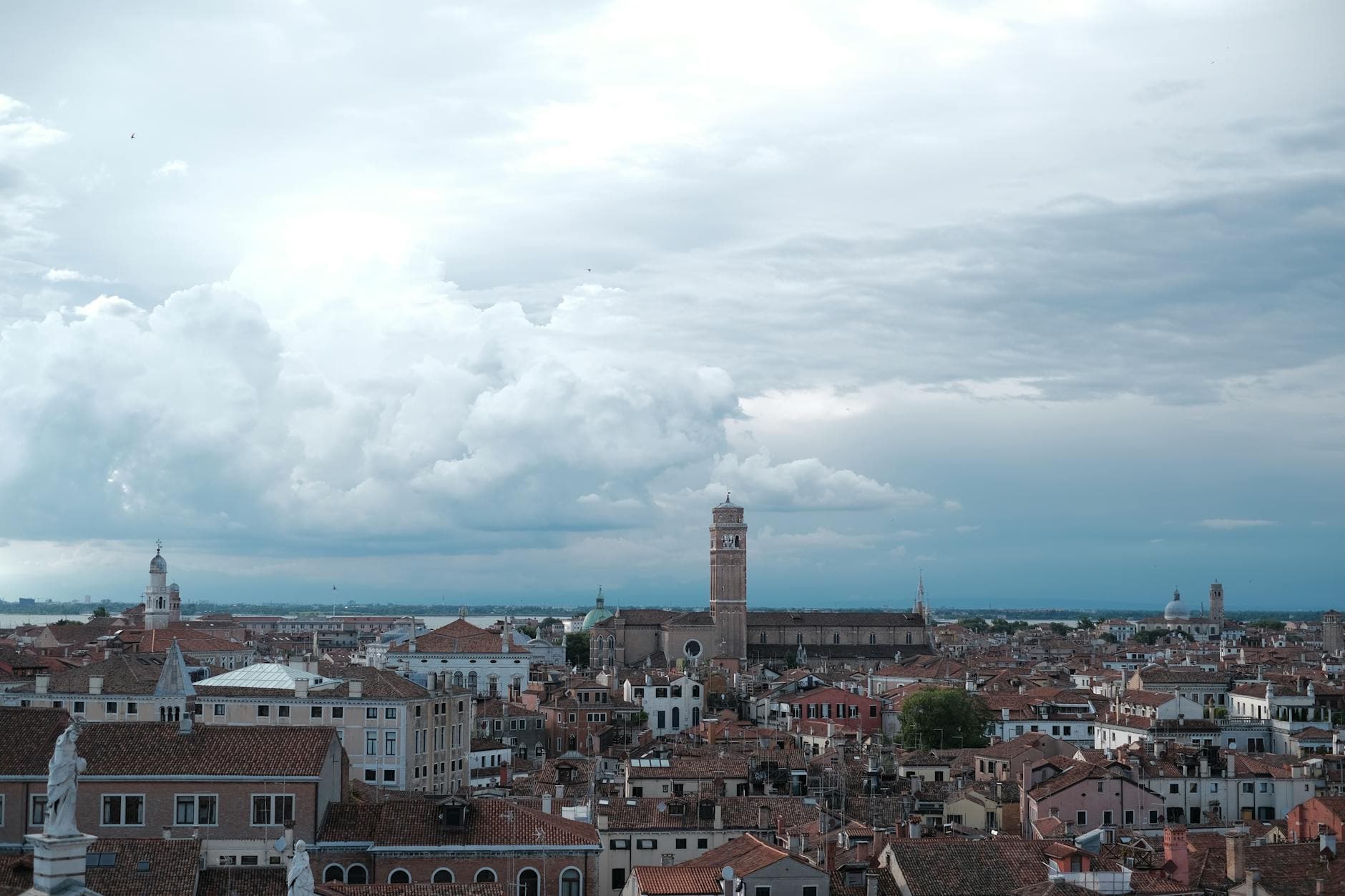 Captivating view of Venice's historic rooftops under a dramatic cloudy sky.