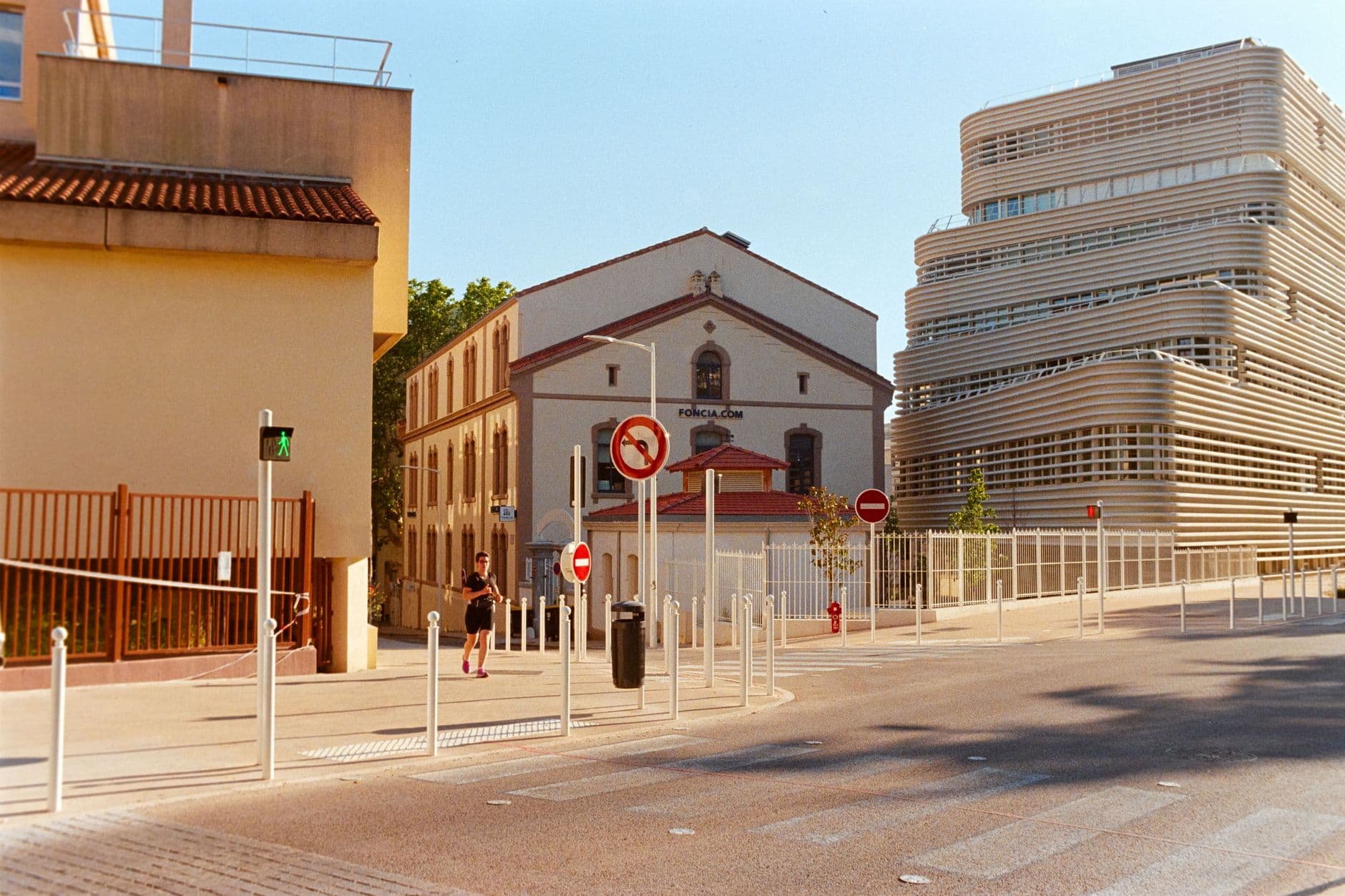 Modern and historic architecture in Toulon with street activity in natural daylight.