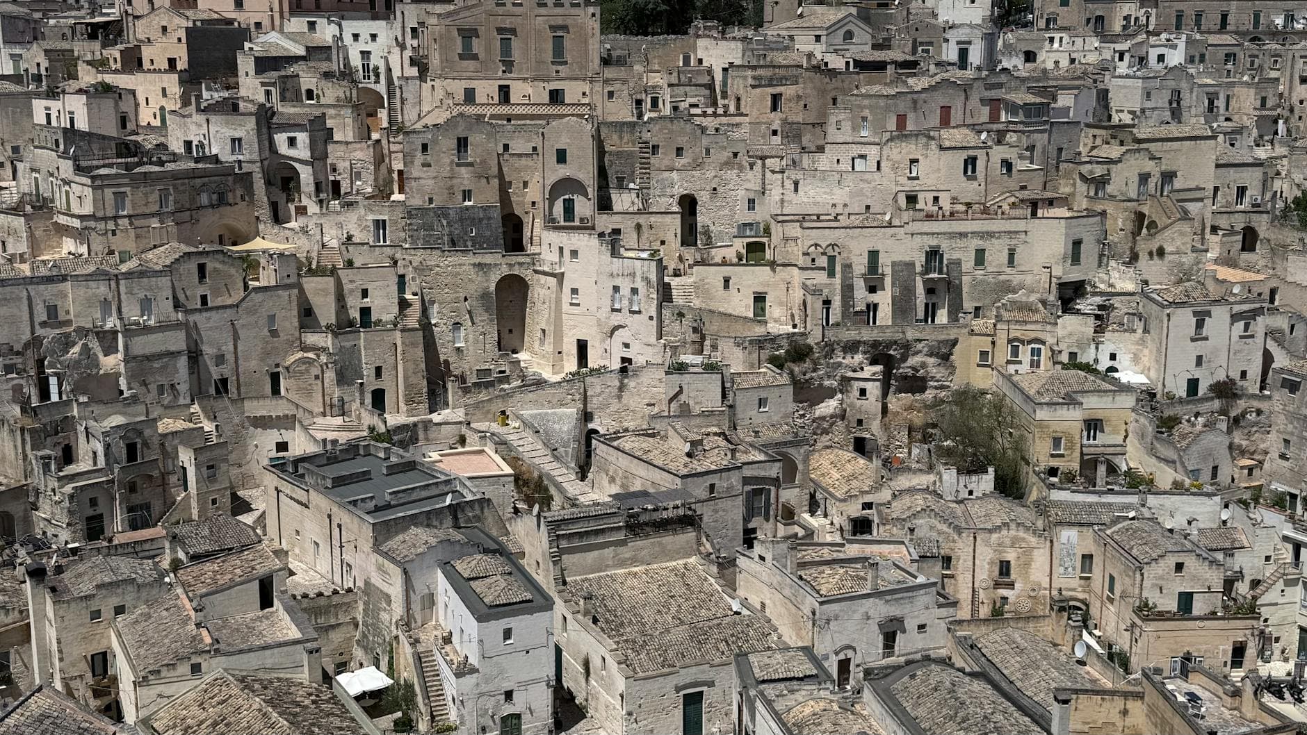 Aerial view of ancient stone buildings in Matera, Italy, showcasing historic architecture.