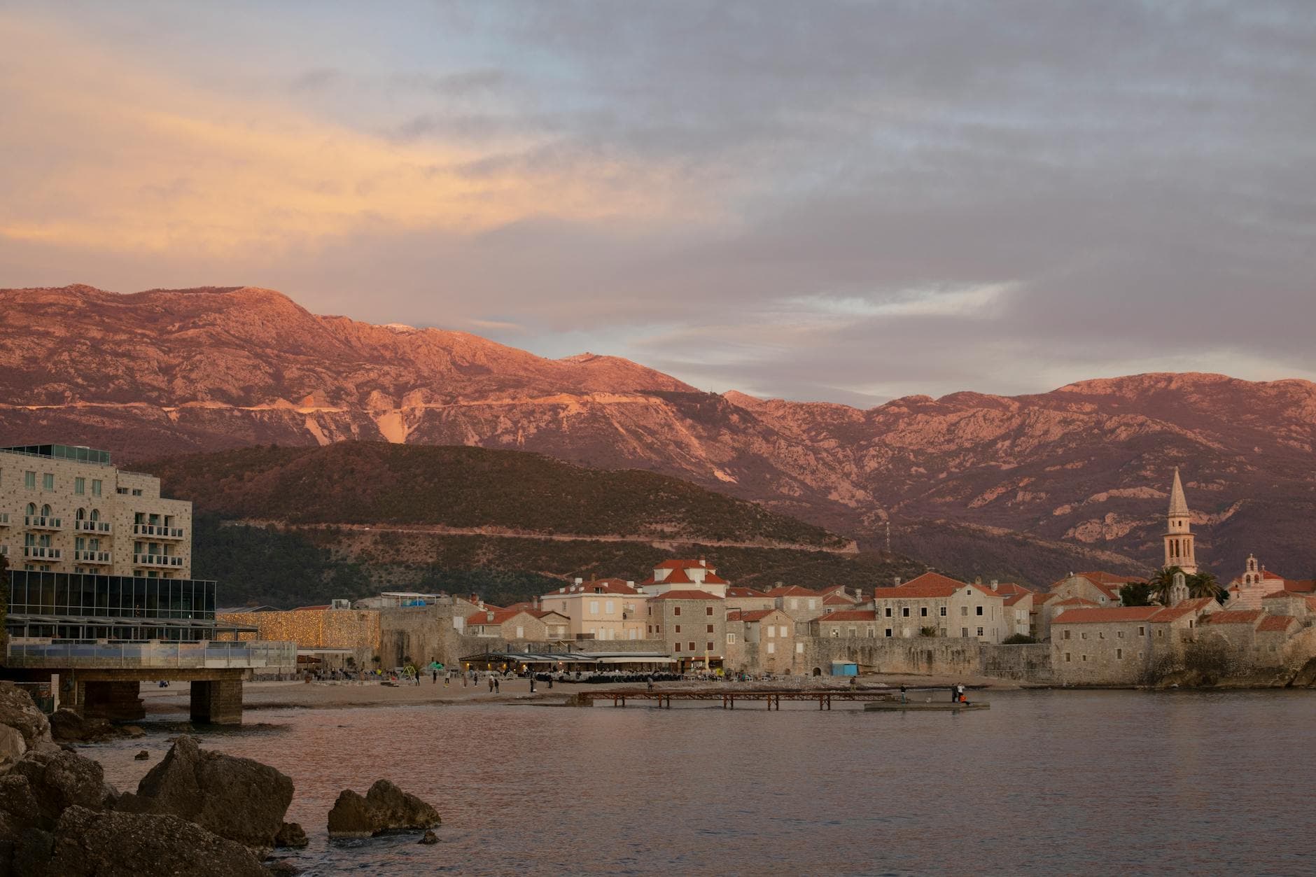 Captivating sunset view over Budva, Montenegro, featuring historic architecture and serene Adriatic waters.