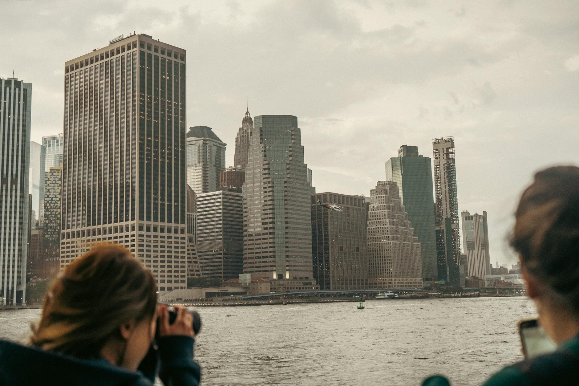 Captivating view of New York City's skyline with skyscrapers from a boat ride on the water.