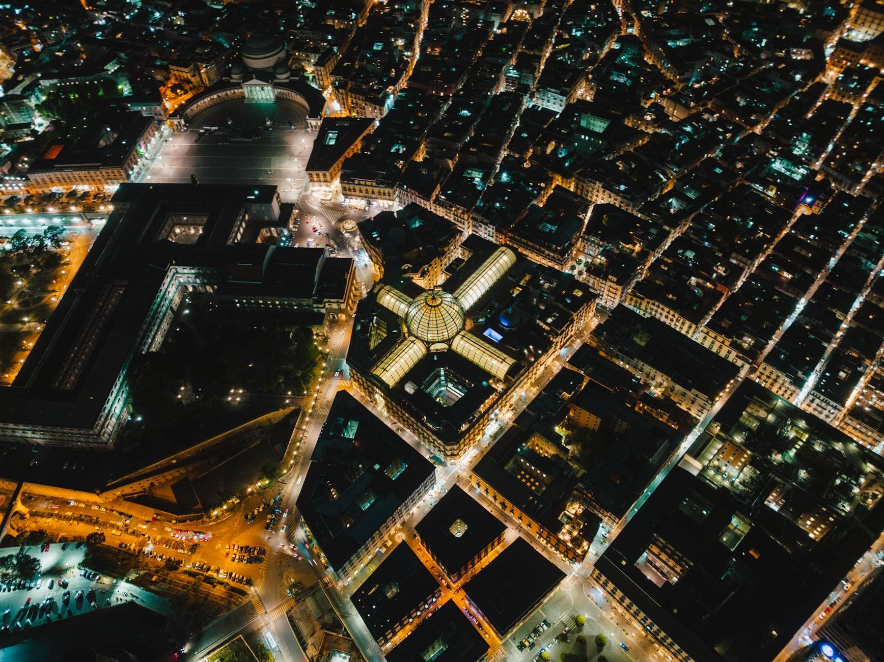 Stunning aerial view of illuminated streets and architecture in Napoli, Italy at night.