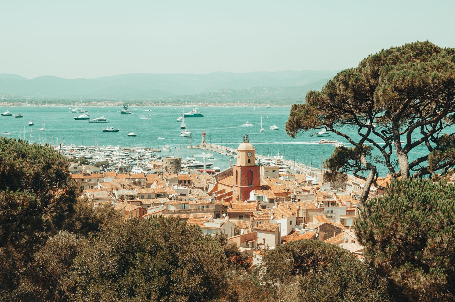 Picturesque view of Saint-Tropez's old town and harbor under a clear sky.