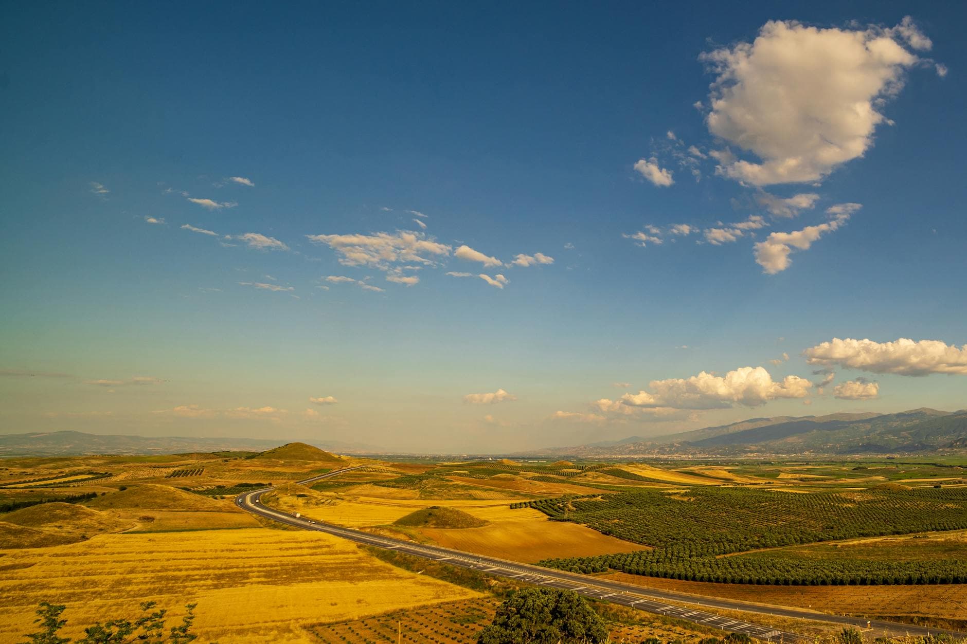 Stunning view of Salihli's rural landscape with golden fields under a bright sky.