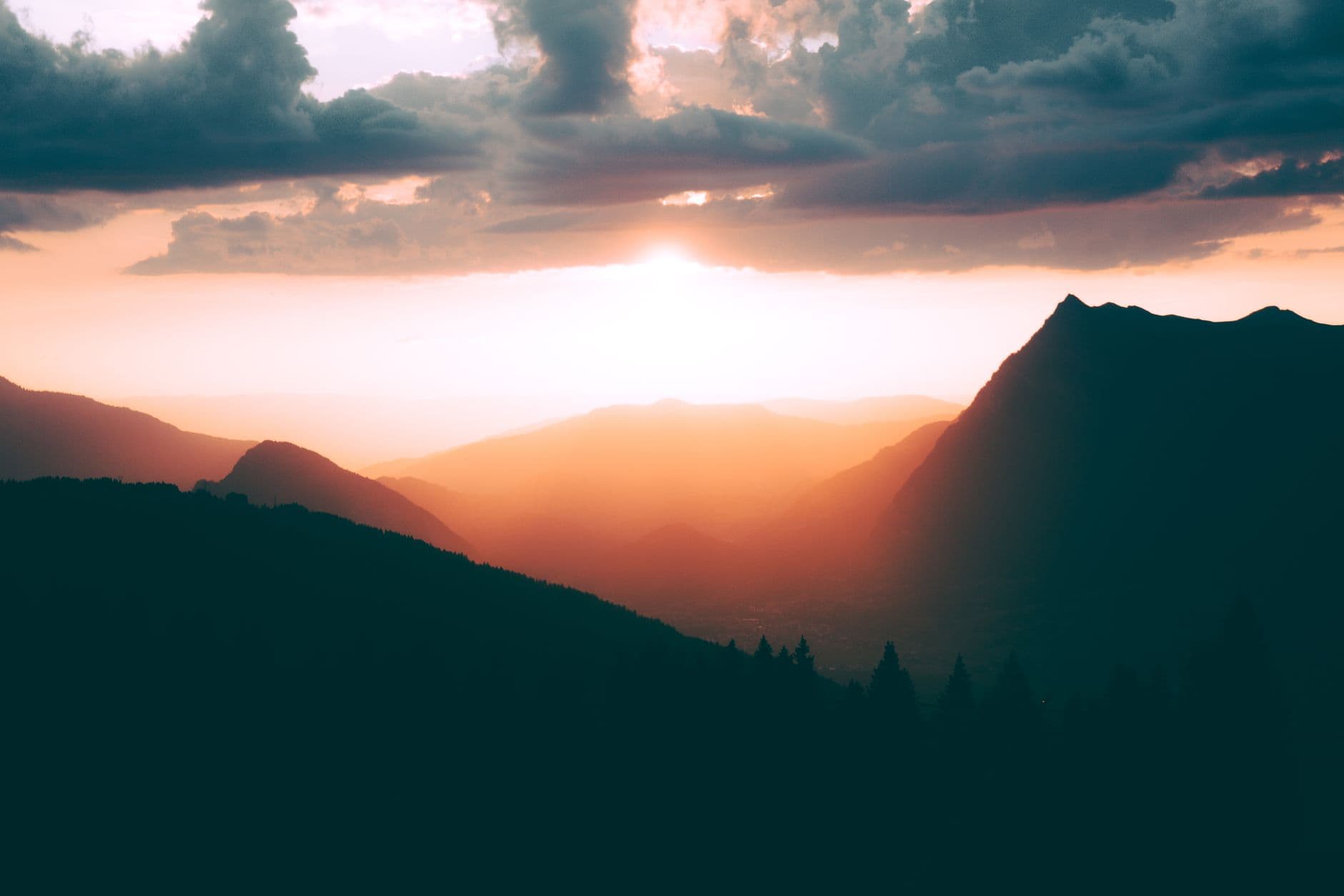 Breathtaking view of sunrise illuminating the mountain landscape in Samoëns, France.