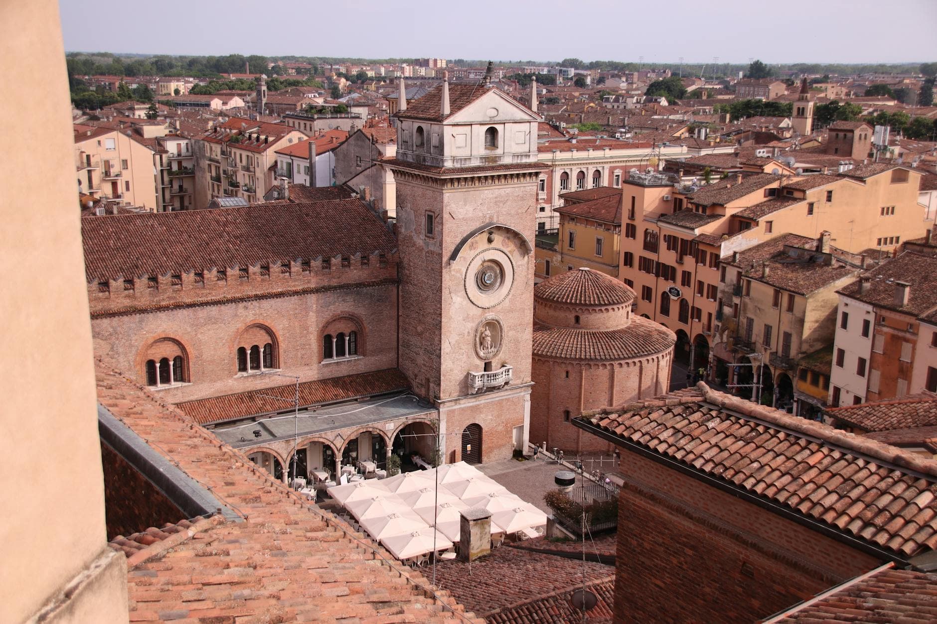 Aerial view of Rotonda di San Lorenzo and historic buildings in Mantova, Italy, under a clear sky.