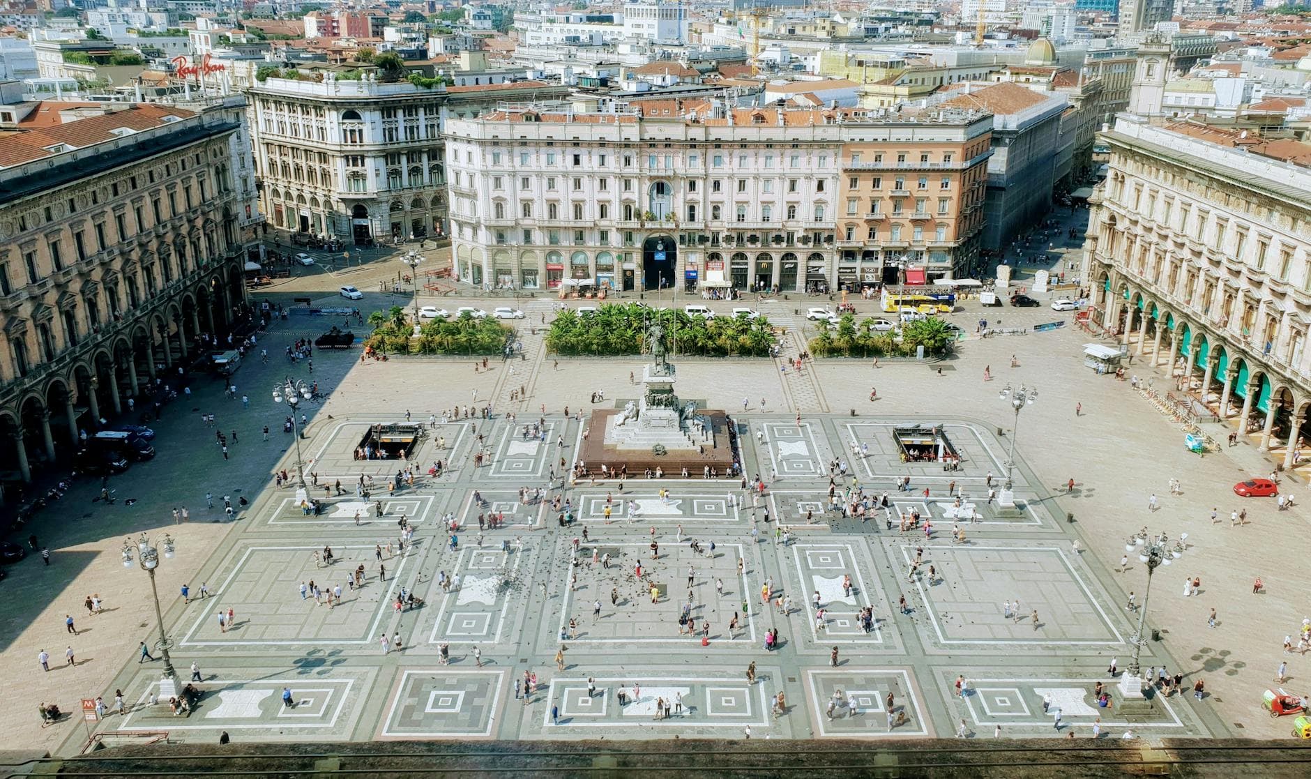 Aerial shot of Piazza del Duomo in Milan, capturing the bustling square and architectural beauty.
