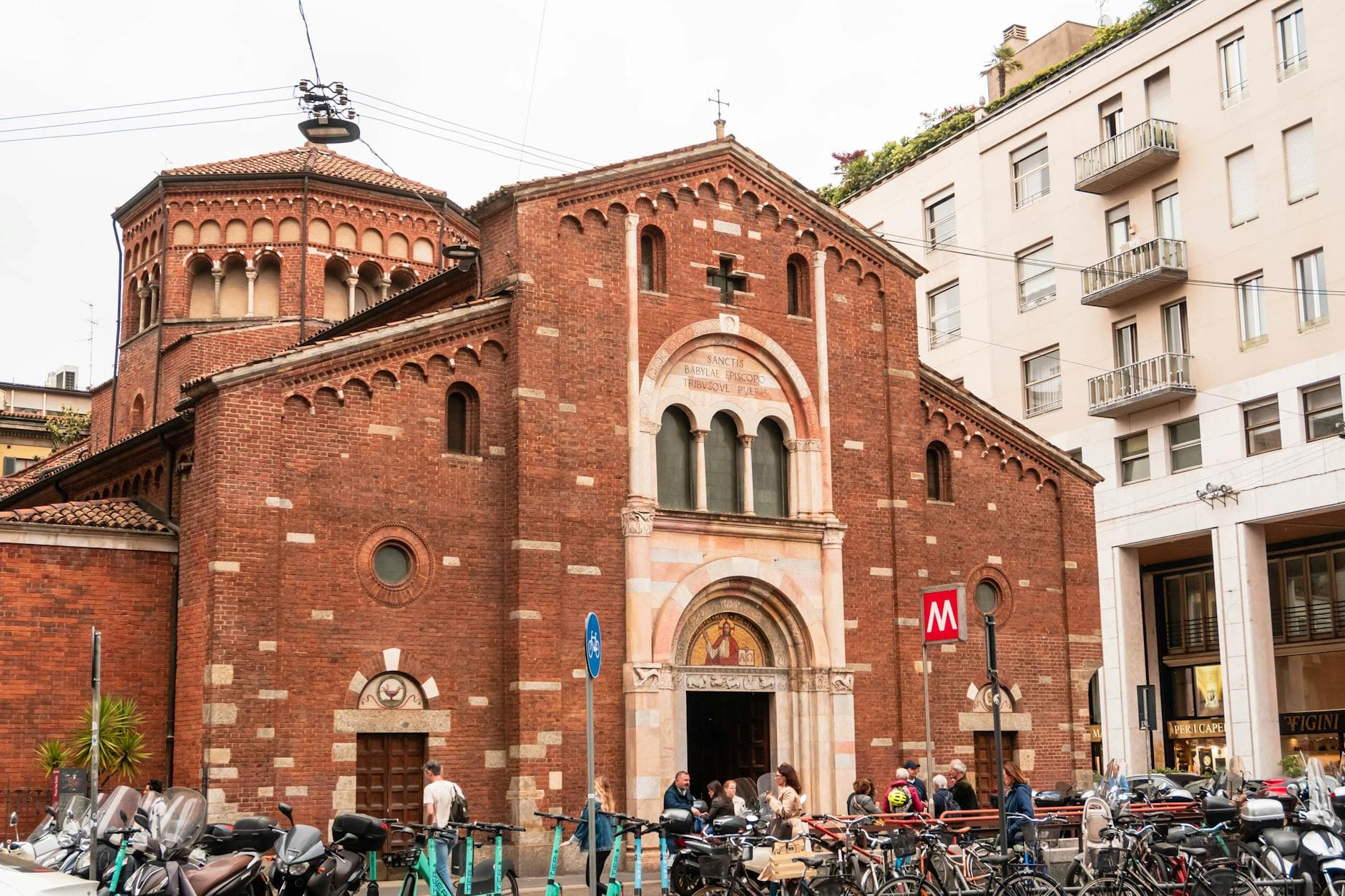 Explore the historic San Babila Church within the bustling cityscape of Milan, Italy.