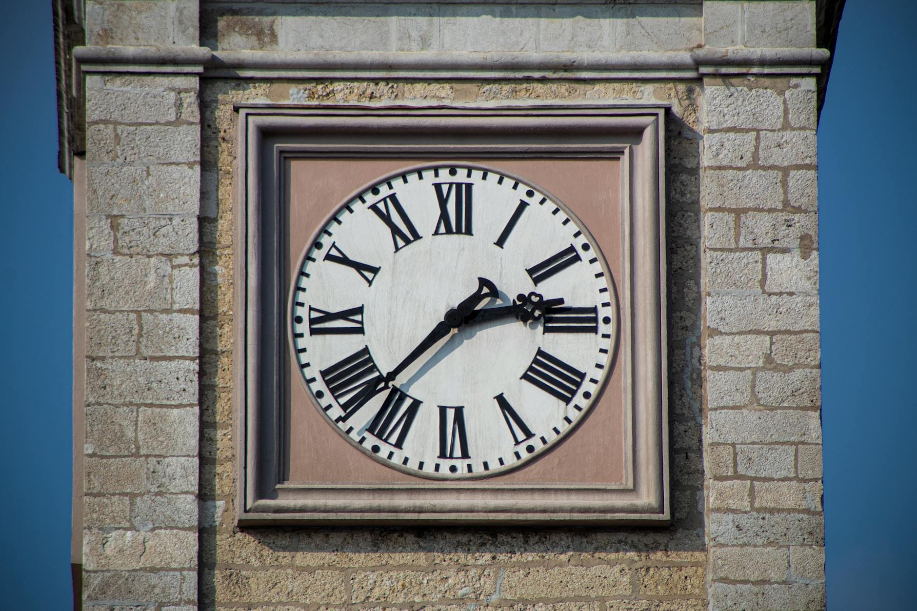 Close-up of the historic clock tower in San Daniele del Friuli, Italy.