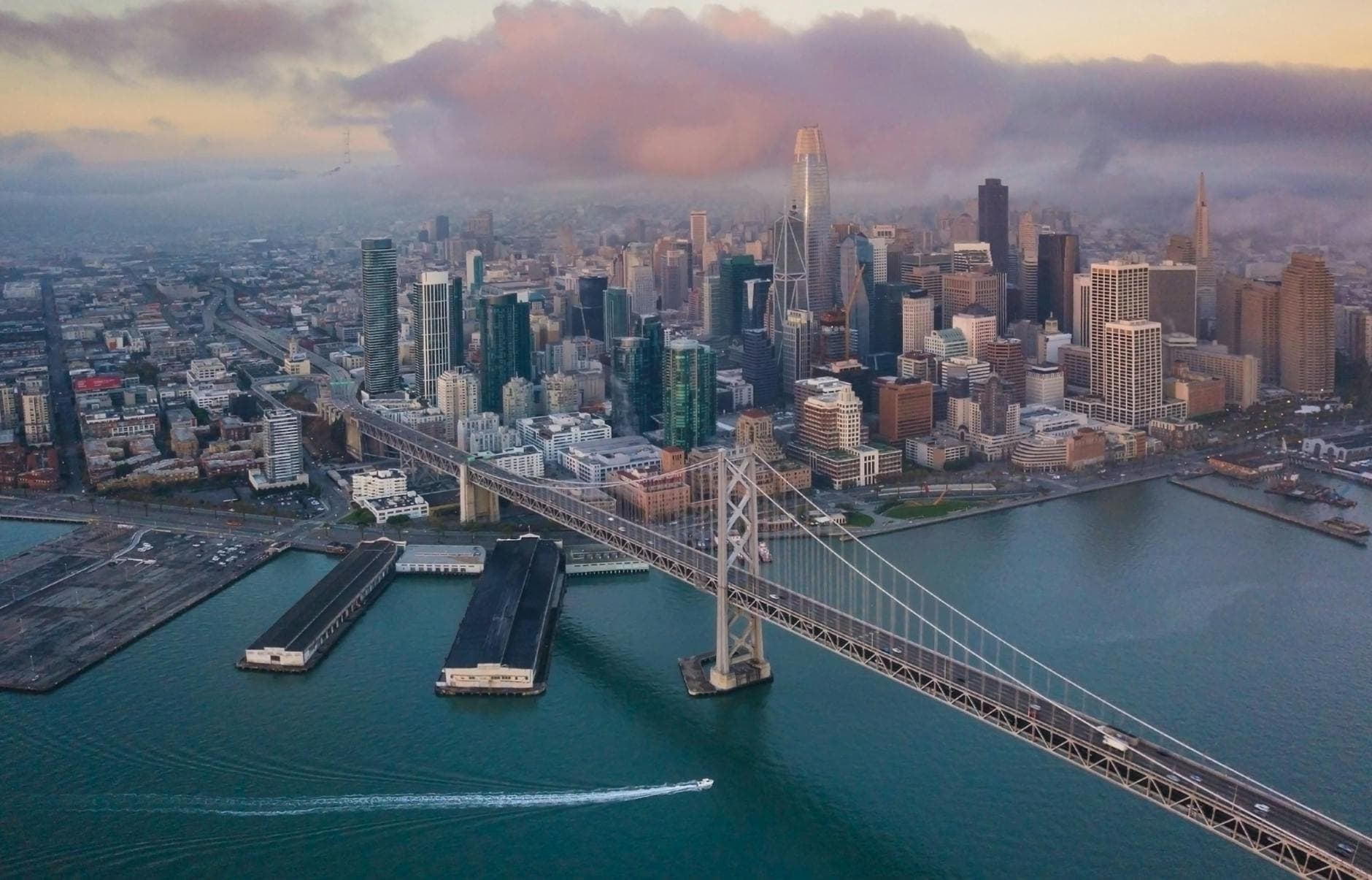 A breathtaking aerial view of the San Francisco skyline and Bay Bridge at dawn.