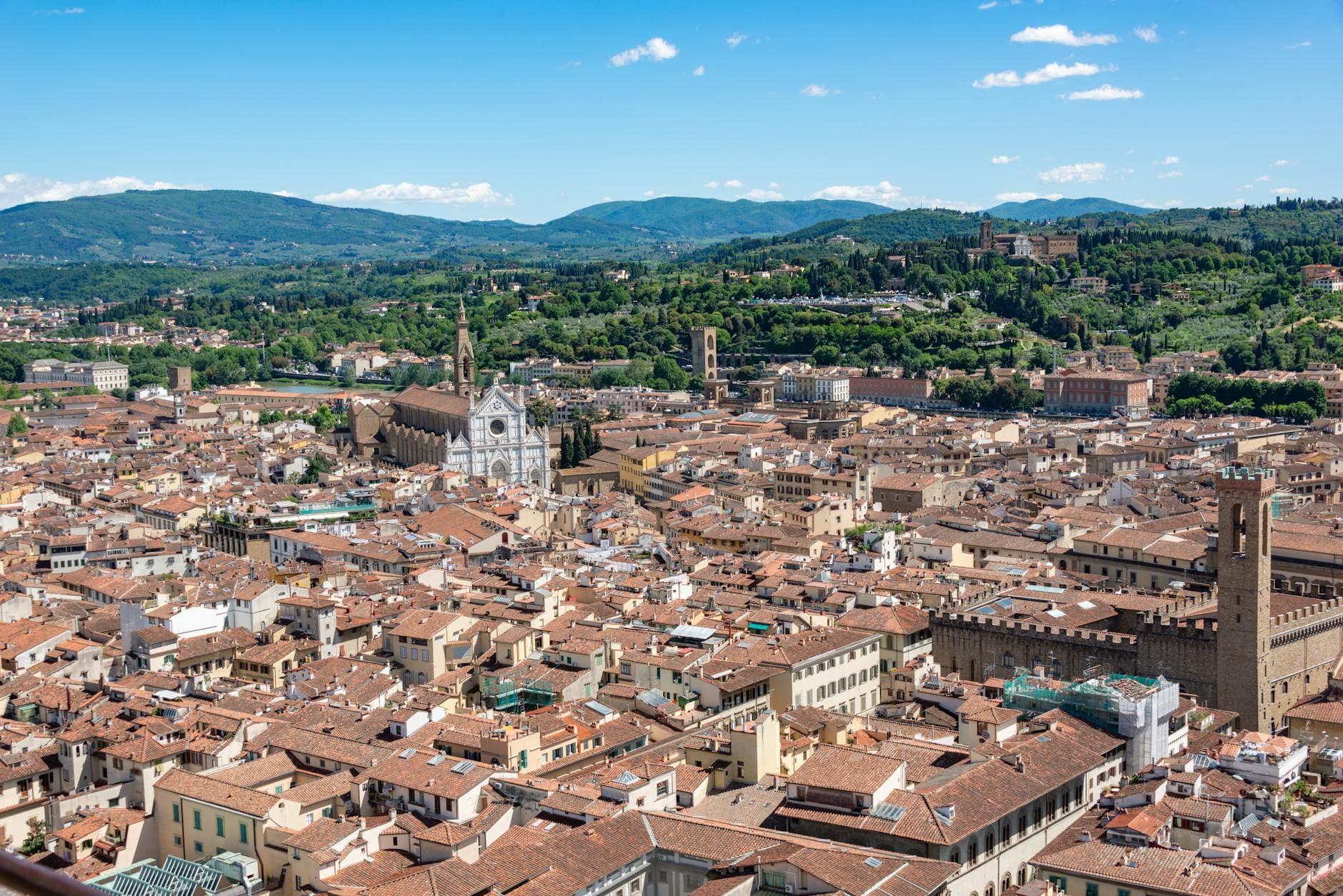 Stunning aerial view of Florence cityscape with Santa Croce Basilica and red rooftops in summer.