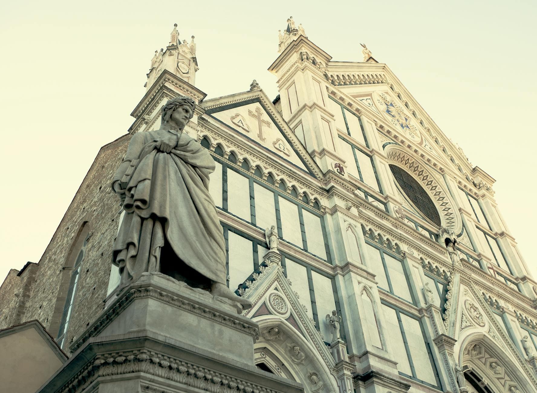 Low angle view of Santa Croce Cathedral's Gothic facade in Florence, Italy.