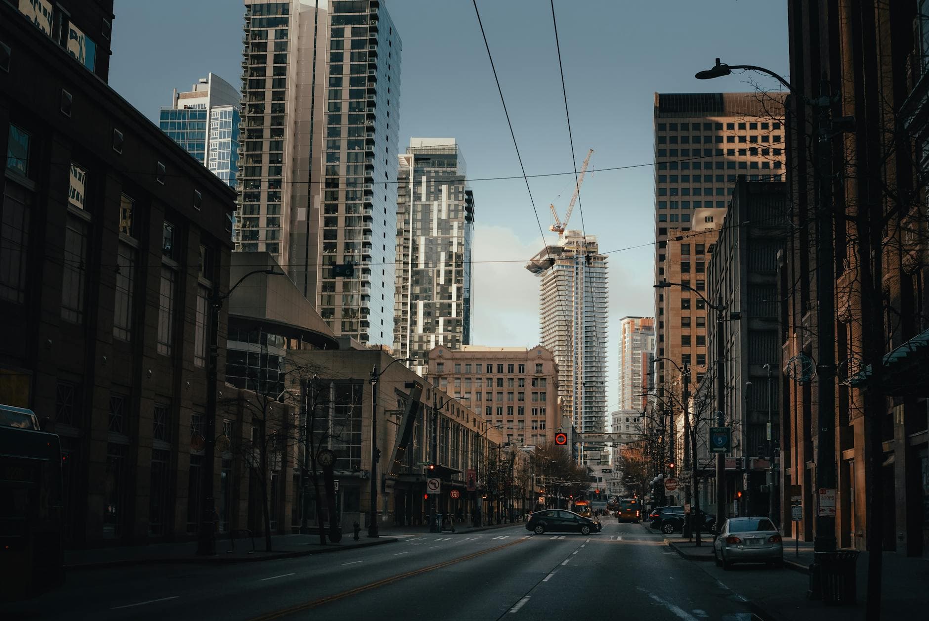 Urban skyline with towering skyscrapers and bustling streets at twilight in Seattle.