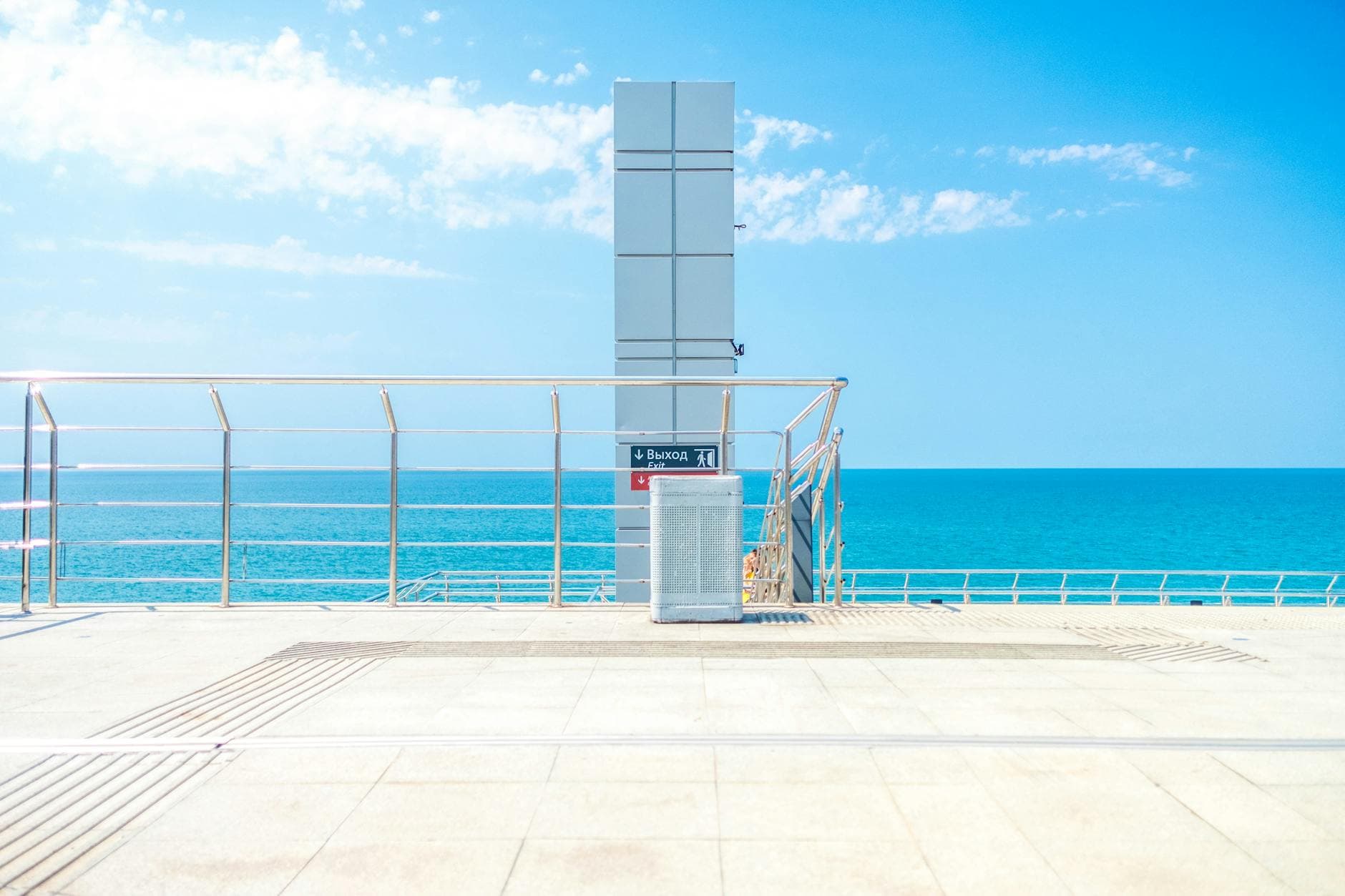Summer view of Sochi's seaside promenade showcasing blue skies and a calm ocean.