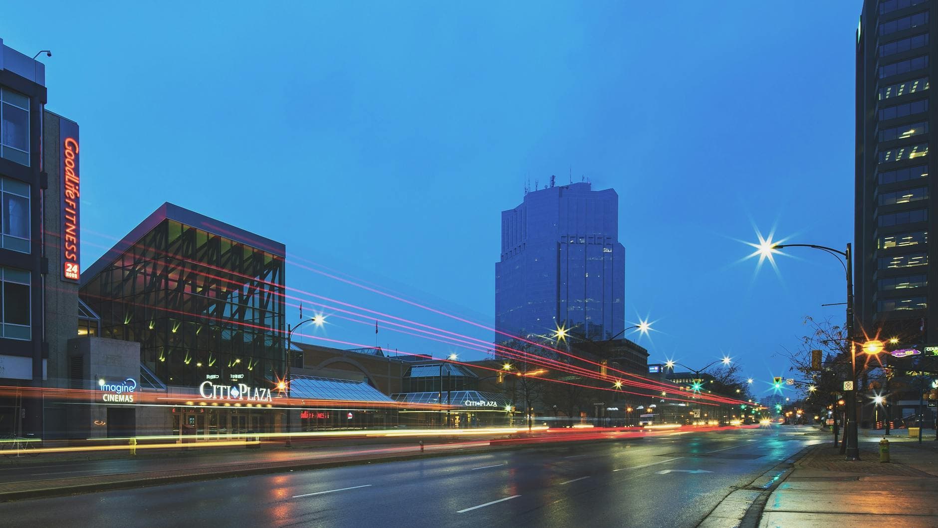Vibrant night cityscape of downtown London, Ontario highlighting light trails and urban architecture.