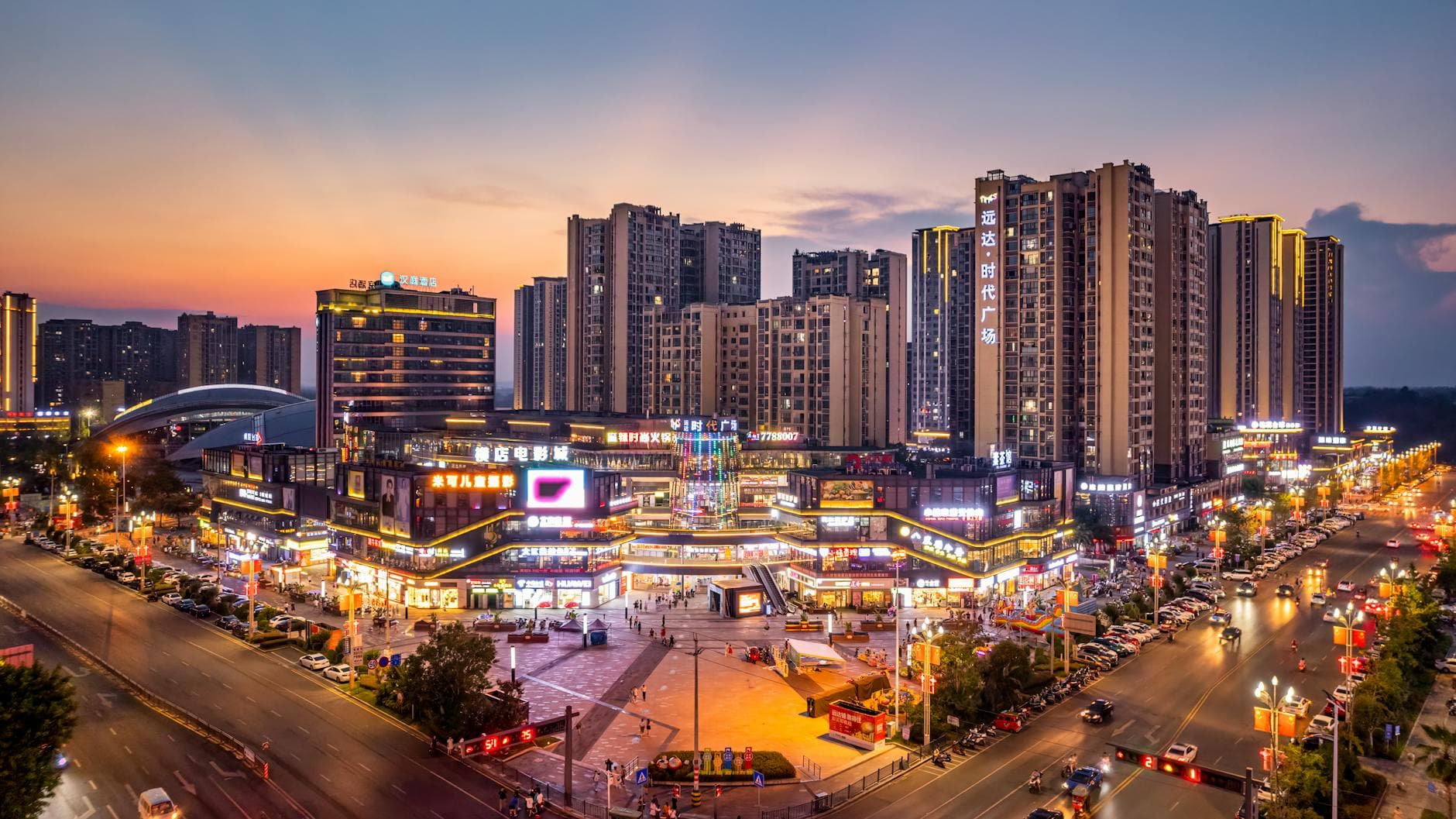 Captivating view of Zigong, Sichuan cityscape at sunset showcasing modern architecture and illuminated streets.