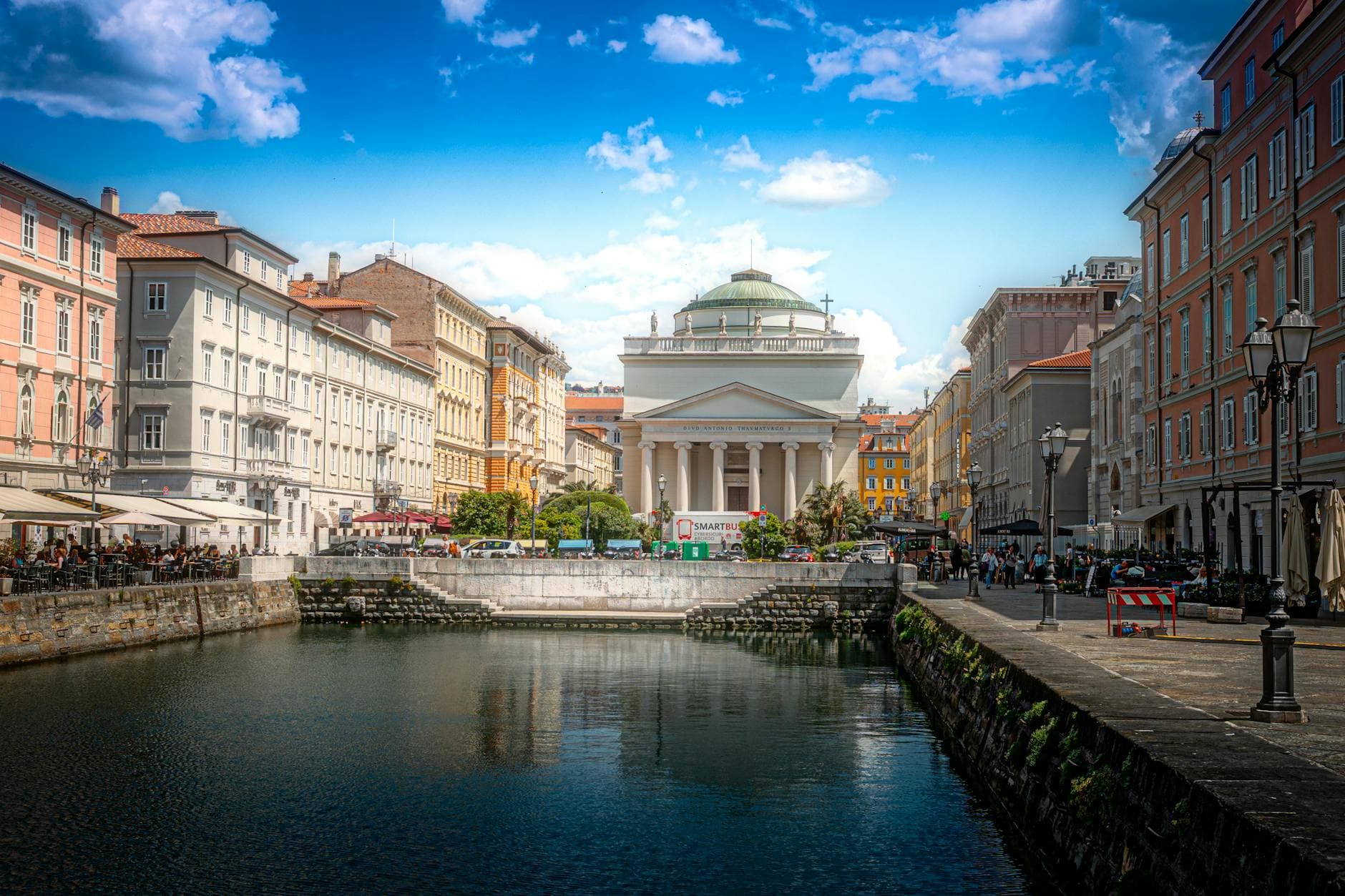 Charming canal view with historical architecture in Trieste, Italy.