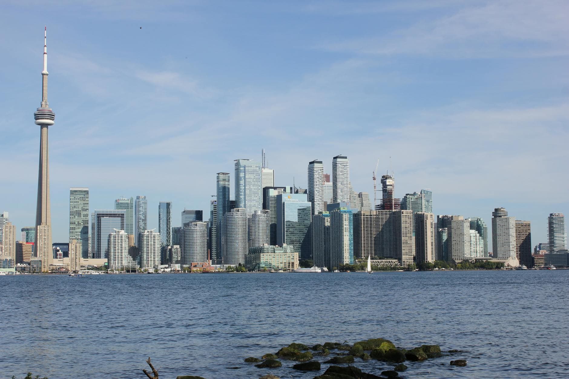 Stunning view of Toronto skyline with iconic CN Tower and waterfront in daylight.