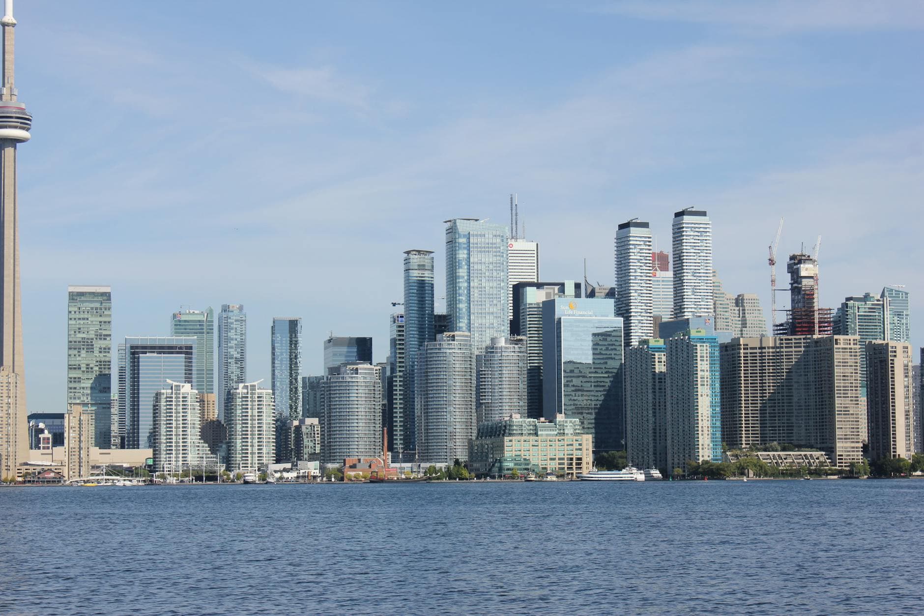Stunning skyline of Toronto with CN Tower and modern skyscrapers under blue sky.