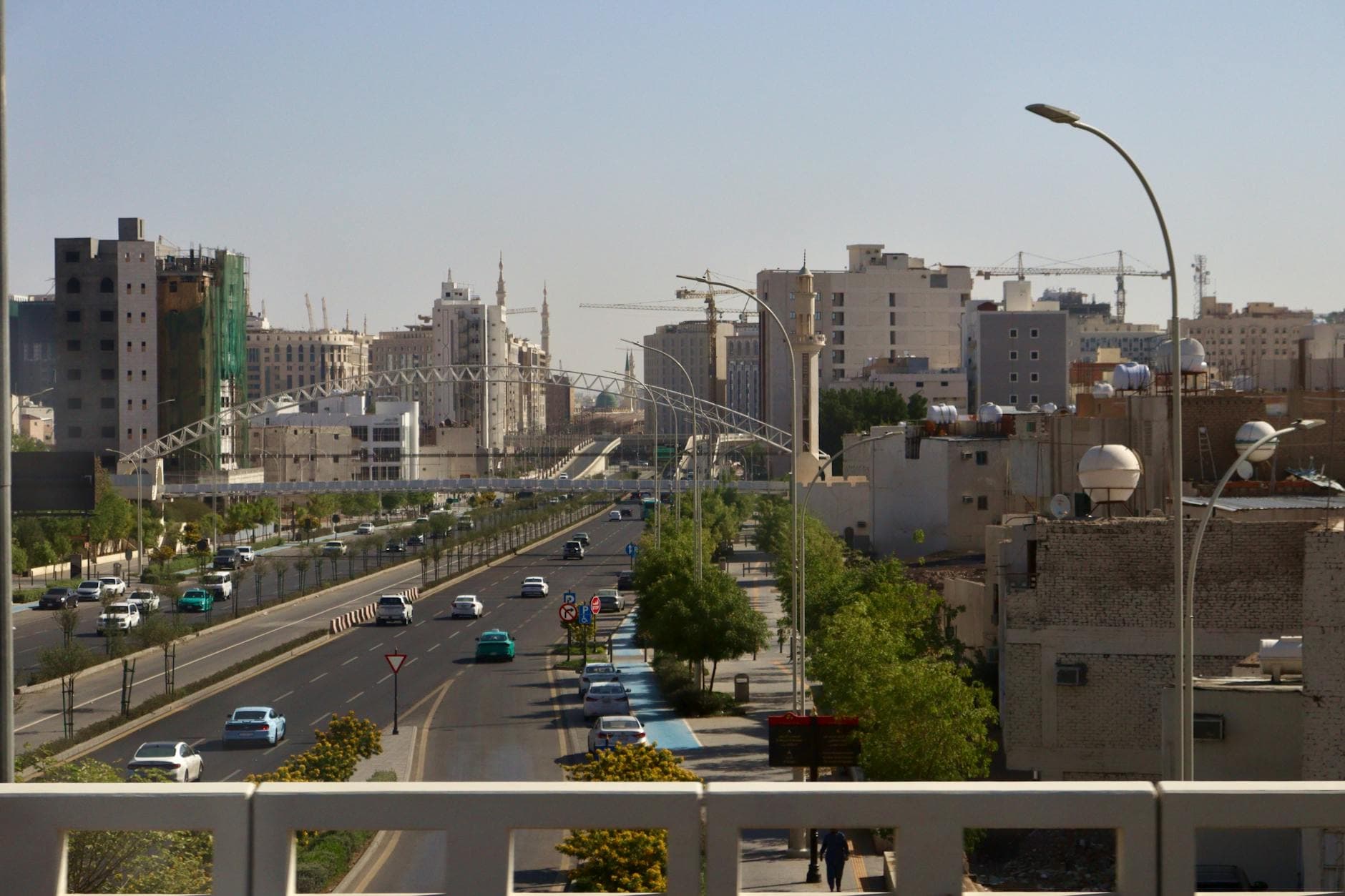 Cityscape of Riyadh with busy streets and modern skyscrapers on a sunny day.